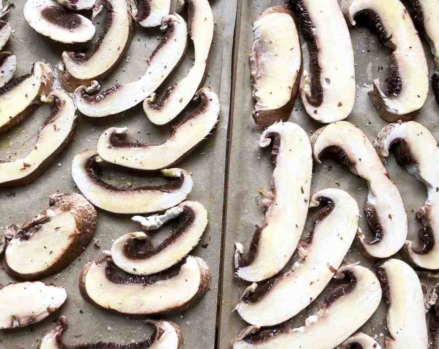 step 7 Arrange the Mushroom Slices (4) on large rimmed sheet pans lined with parchment paper. Brush generously with olive oil and sprinkle lightly with salt and pepper.