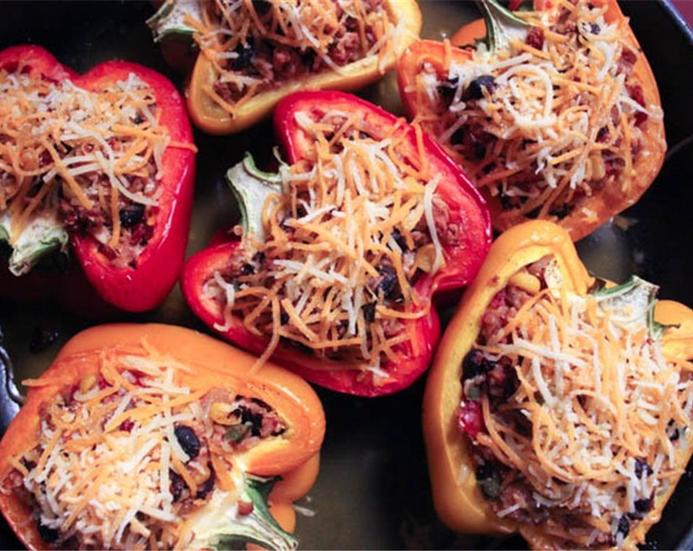 step 12 Remove the foil from your baking dish. Combine the Monterey jack and cheddar cheeses and sprinkle the mixture on top of each stuffed pepper. Bake the peppers uncovered for another five minutes until the cheese is melted and bubbling.