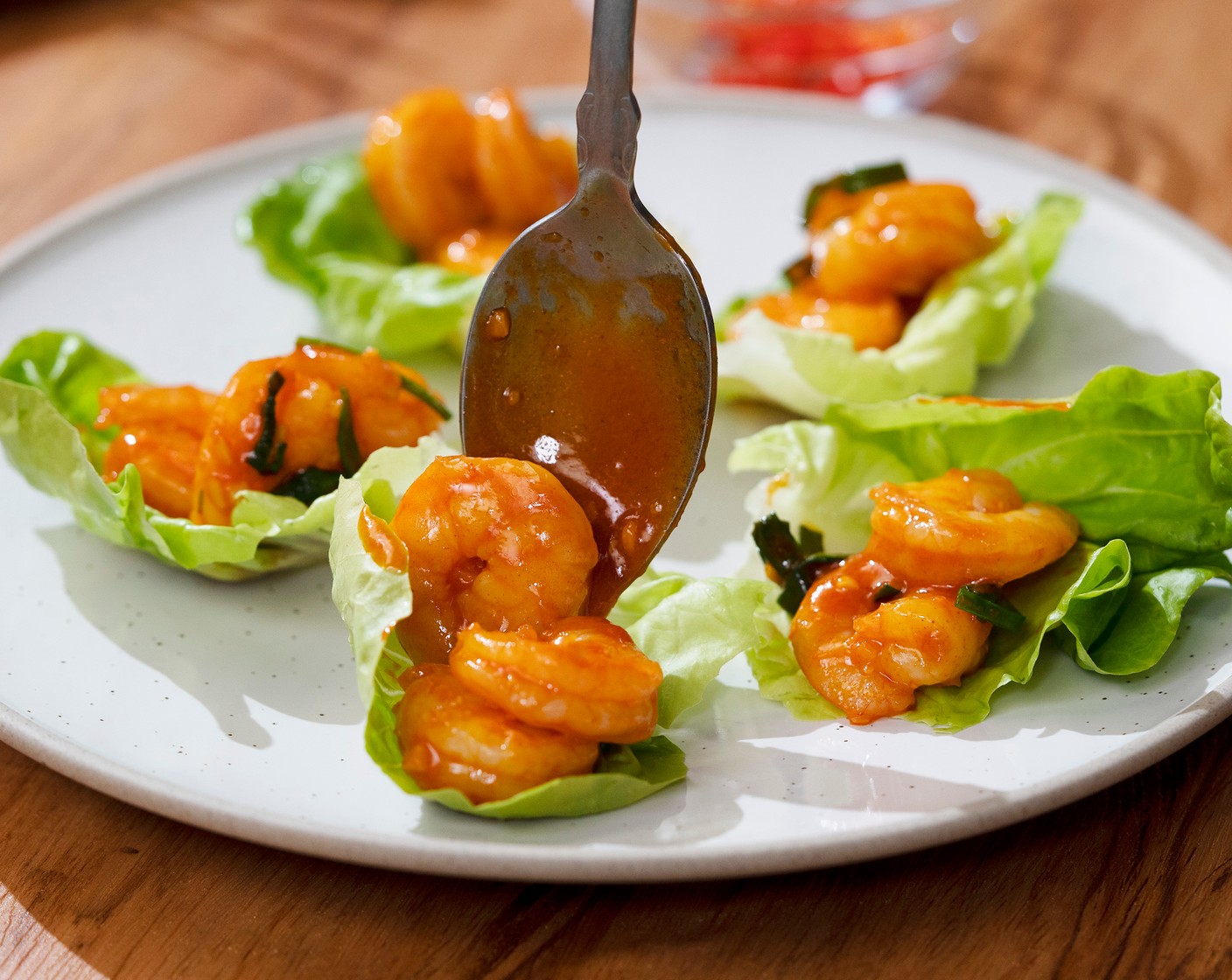 step 5 Top Butter Lettuce (8 pieces) with gochujang shrimp. Garnish with Scallions (to taste), Red Chili Peppers (to taste), and White Sesame Seeds (to taste). Serve with Lemon (1).