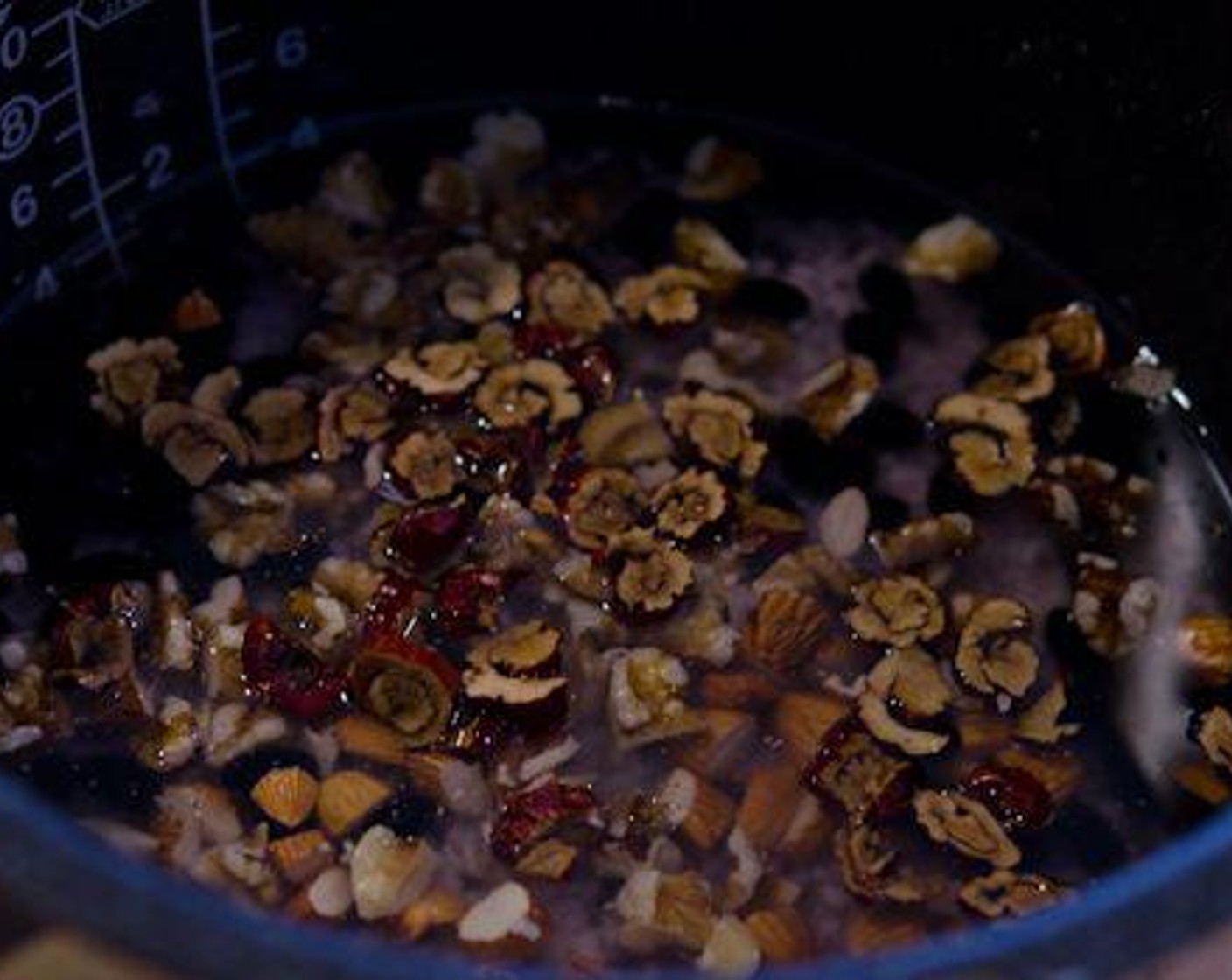 step 2 Add Walnut (1/3 cup), Almonds (1/3 cup), Dried Red Dates (6), Salt (1/4 tsp), and Canola Oil (1/2 tsp). Pour Water (1 Tbsp) to the pot and let the rice cooker do the cooking.
