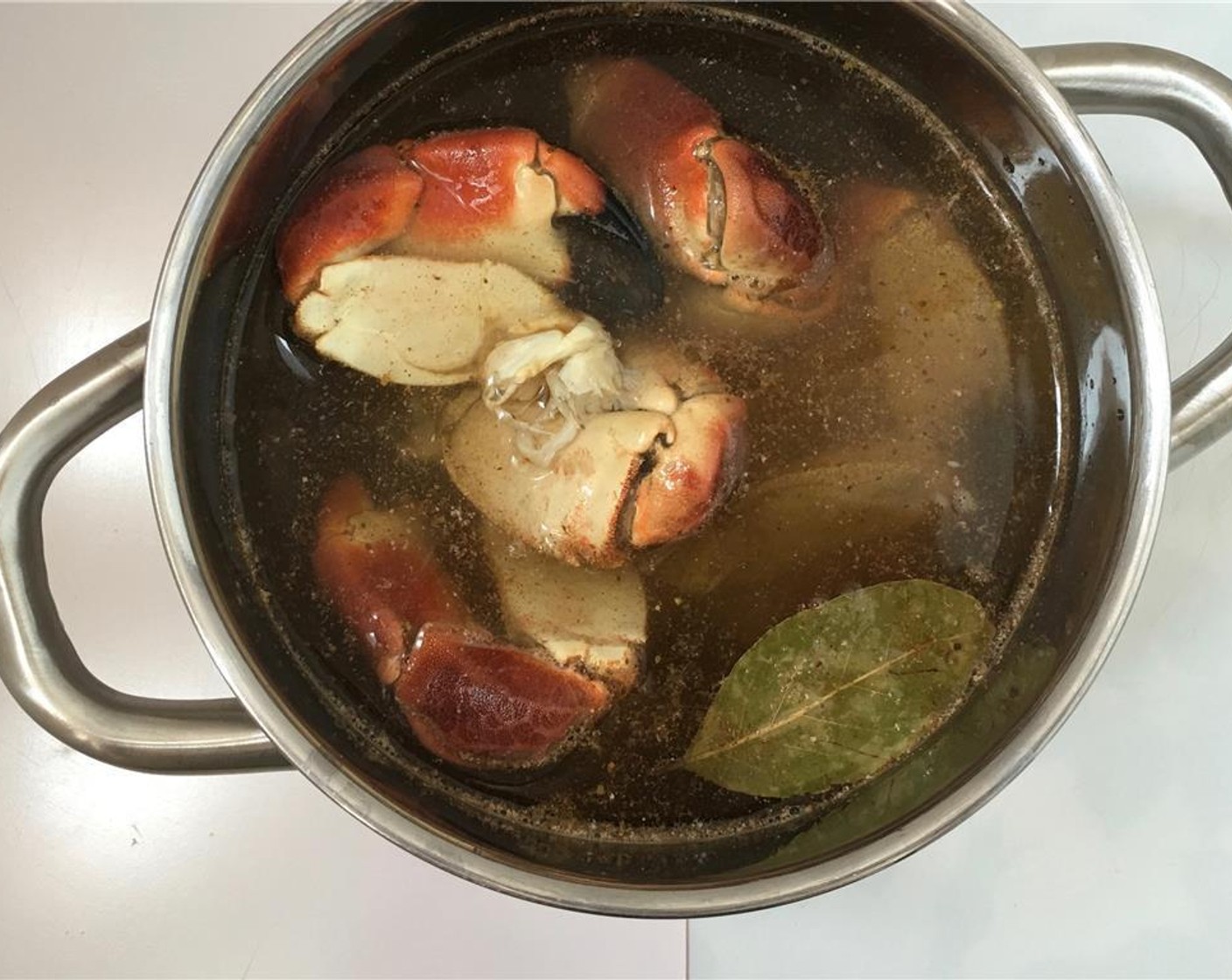 step 2 Place the pan over high heat and bring the water to a good boil. Then add Stone Crab Claws (8).
