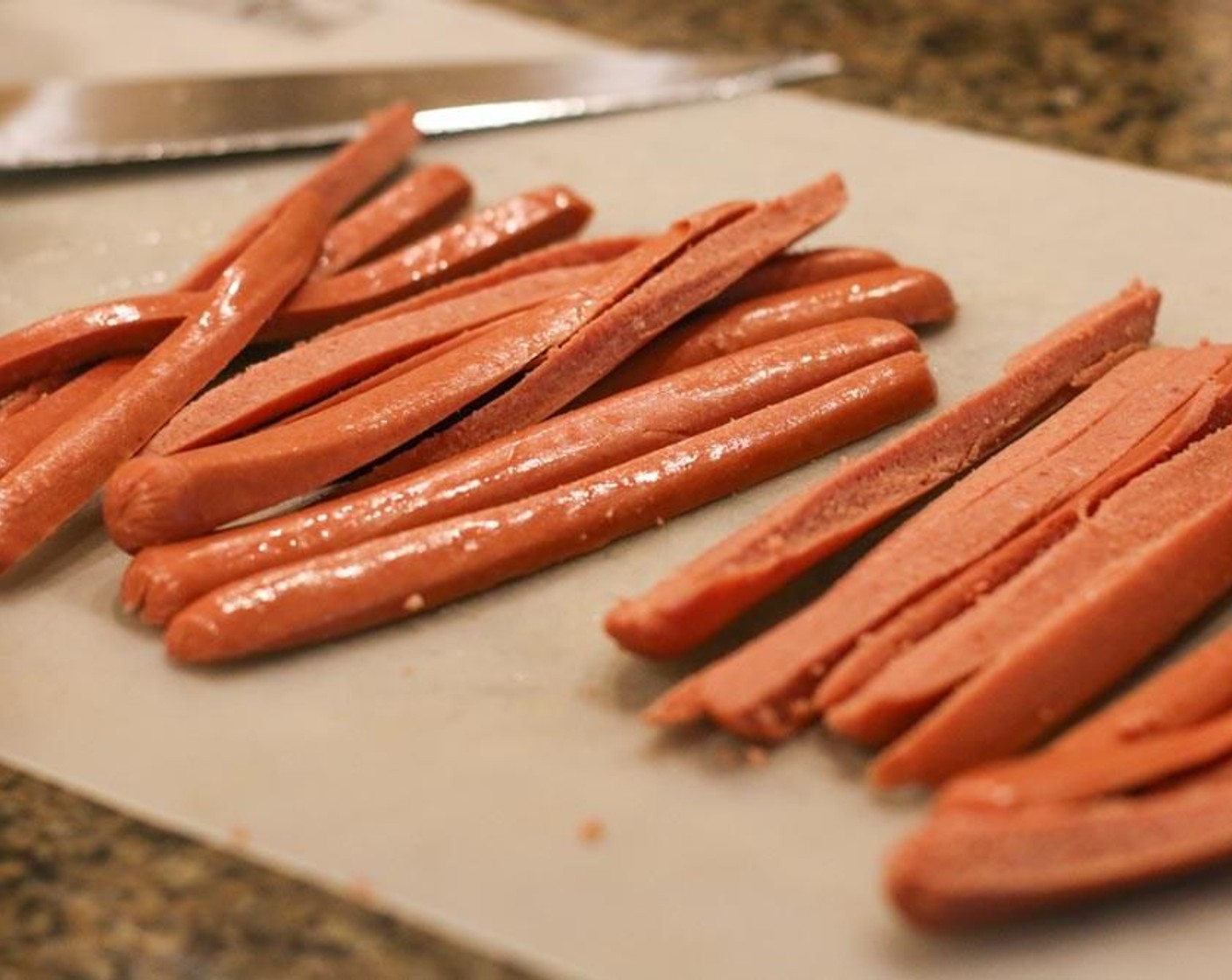 step 1 Slice Hot Dog (1 pckg) individually into four pieces, lengthwise.