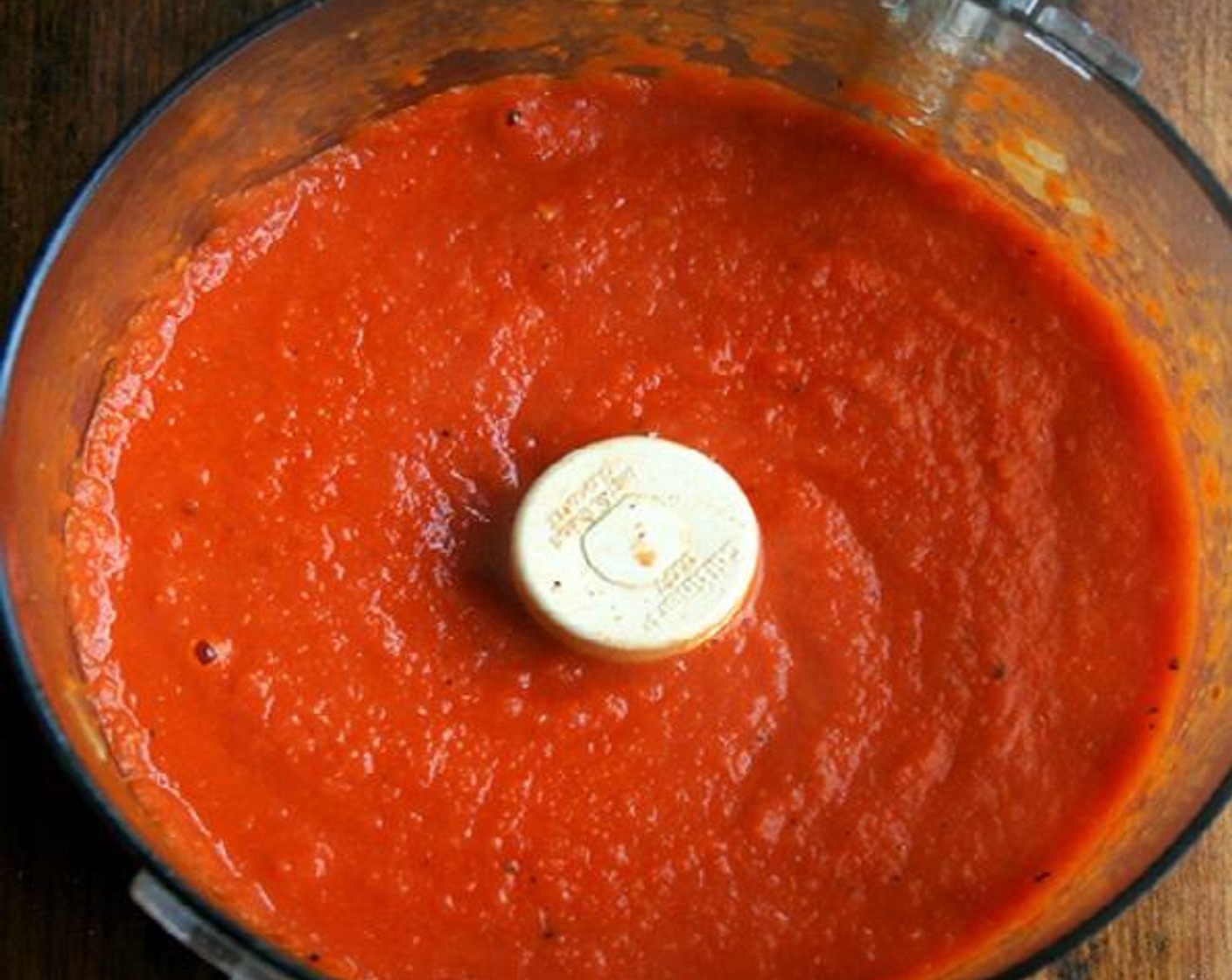 step 6 Place the tomato mixture in a blender or food processor and purée in batches until the sauce is a smooth consistency. Place potholders or dishtowels around the handles of your pot to prevent burning your hands in the next step. Return sauce to the pan.