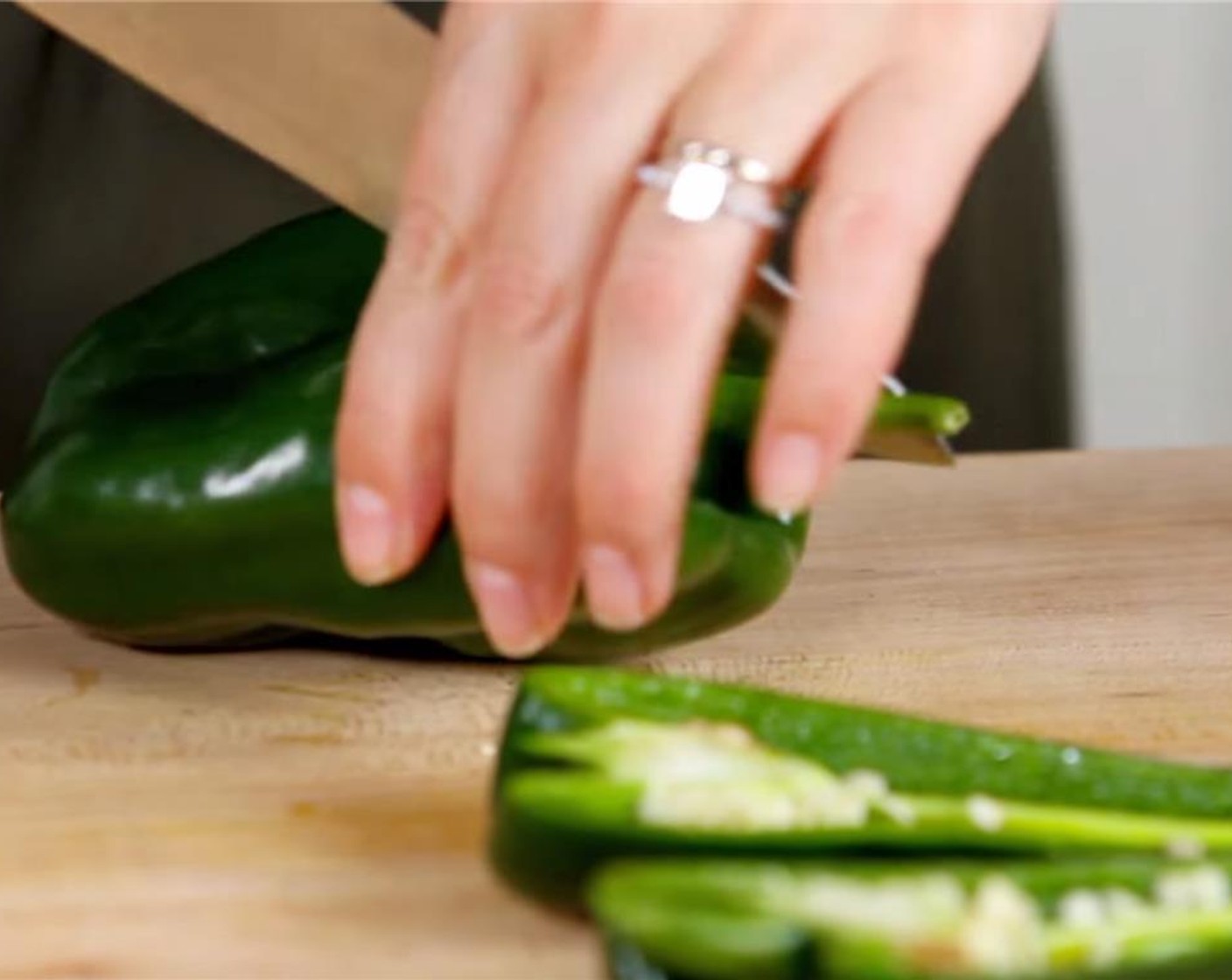 step 3 Chop the Onion (1) and set aside. Cut the Poblano Peppers (6) into halves and deseed them. Place the chile halves into another large bowl. Add Olive Oil (2 Tbsp) and toss to coat.