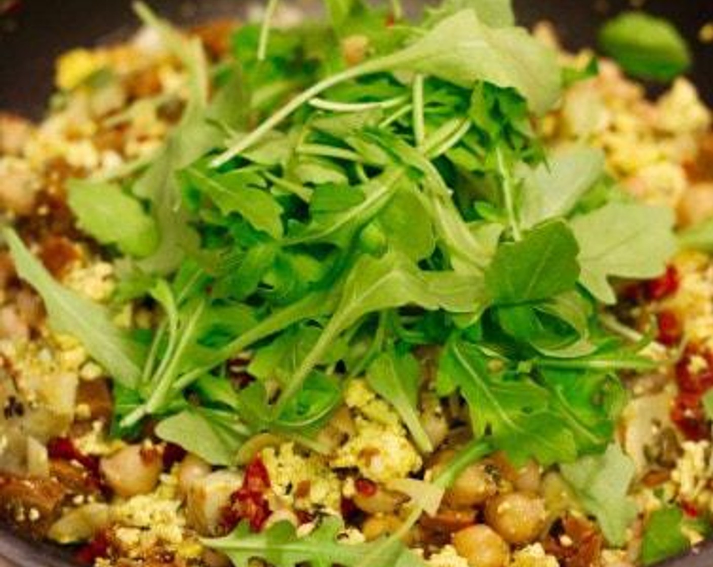 step 6 Add the Arugula (to taste) and stir in. Let scramble cook, occasionally stirring for 2-3 minutes.