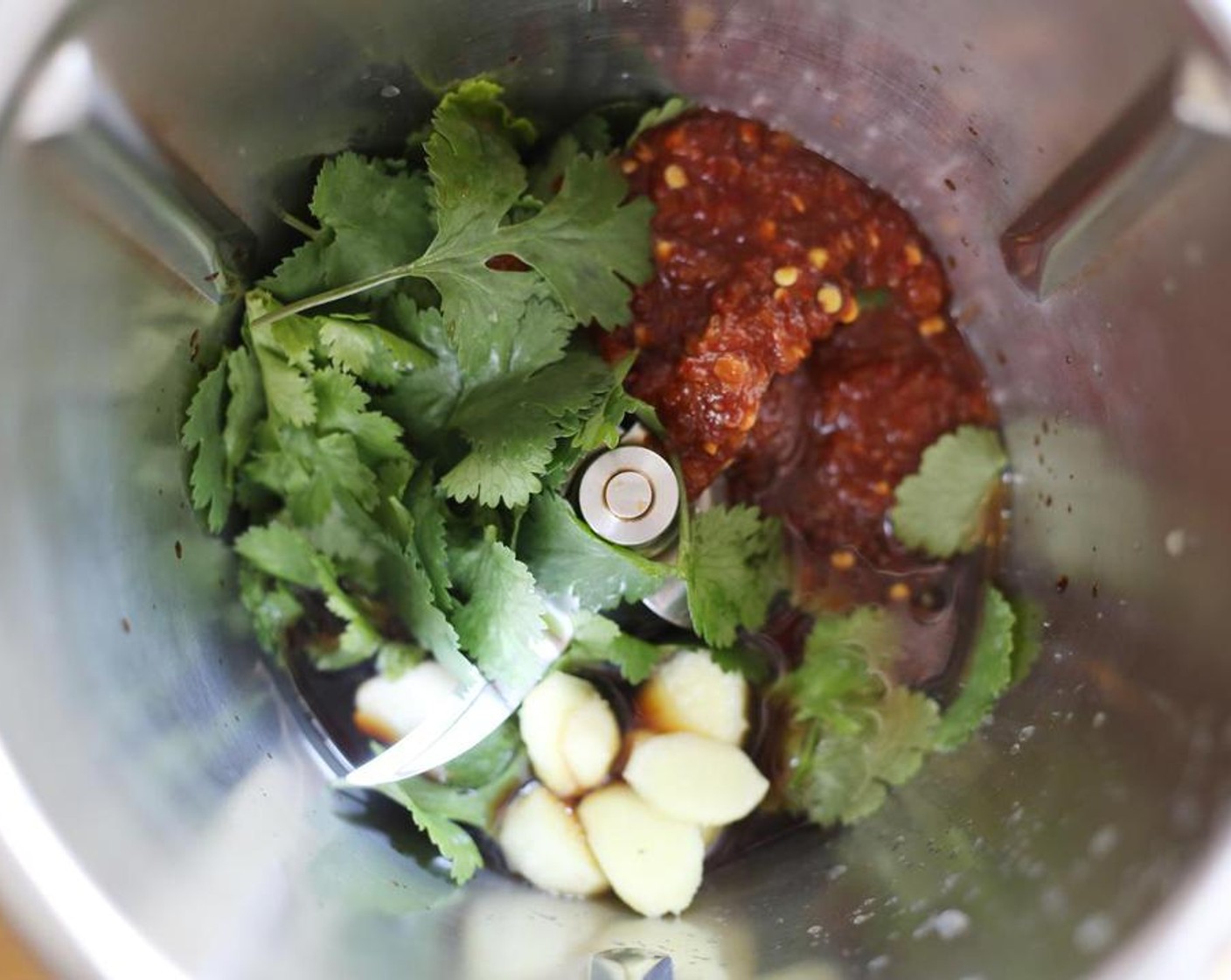 step 1 To make the marinade, combine the Soy Sauce (1/4 cup), Fresh Cilantro (1/4 cup), Garlic (4 cloves), Sambal (3 Tbsp), juice from Lime (1) and Fresh Ginger (1 tsp) in a high-speed blender.