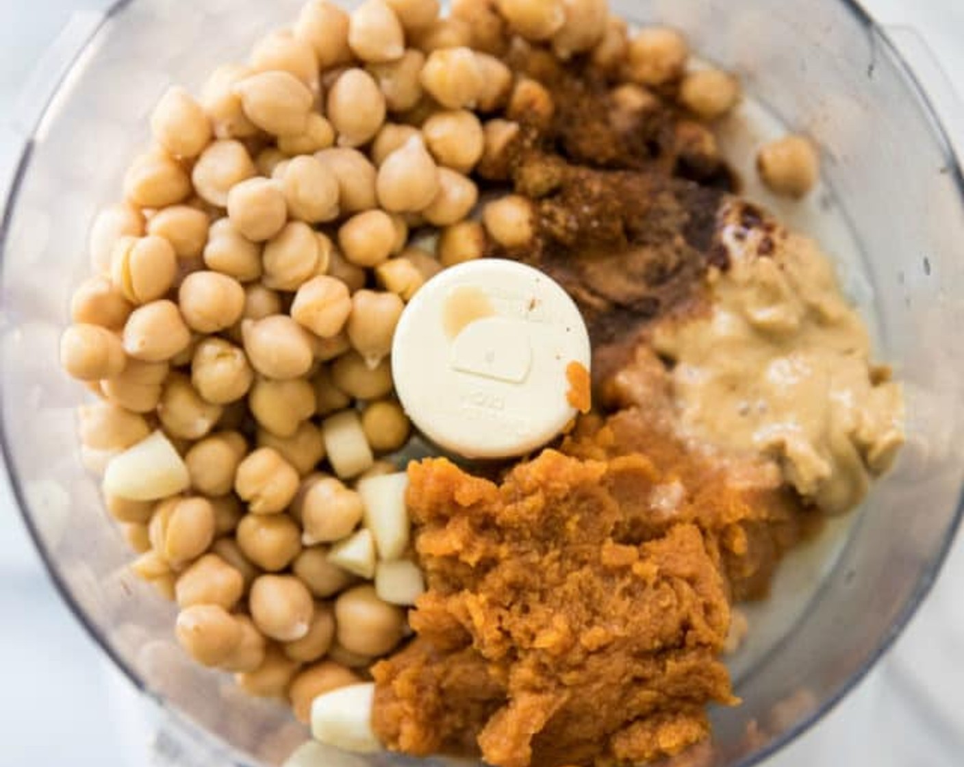step 1 Combine Pumpkin Purée (1/2 cup), Chickpeas (1 can), {@10:}, Garlic (2 cloves), Tahini (2 Tbsp), Extra-Virgin Olive Oil (3 Tbsp), {@11:}, Sea Salt (1/2 tsp), Ground Cumin (1/2 tsp), Chili Powder (1/2 tsp), Ground Cinnamon (1/4 tsp), and Cayenne Pepper (1/8 tsp) in the bowl of a food processor or high-speed blender. Process or blend until smooth, stopping occasionally to scrape down sides of bowl or pitcher.