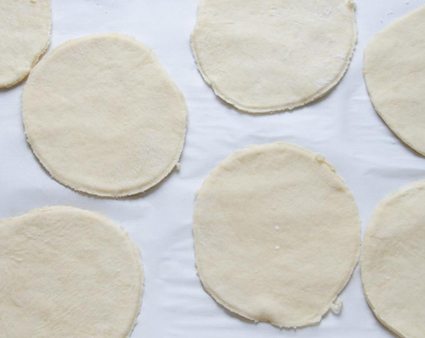 step 11 Cut the dough into 5-inch rounds and transfer to a baking sheet covered with parchment paper. Repeat until all the dough has been rolled and cut.