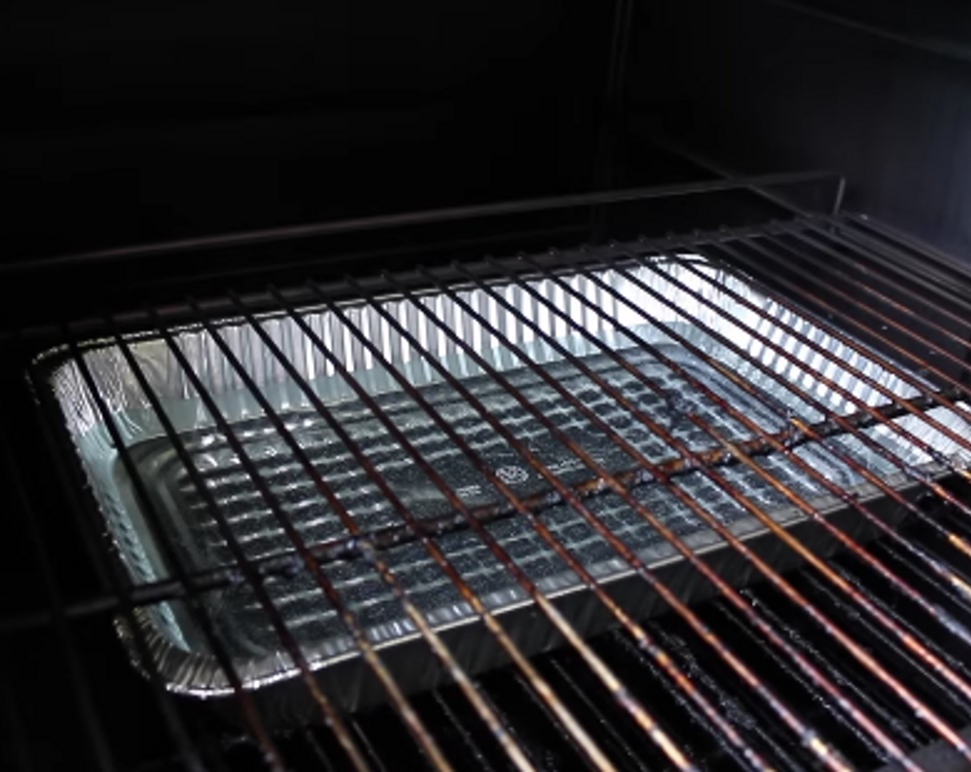 step 3 Place Full Size Aluminum Pan filled half way with water on lower cooking grate. Water Pan should be between cooking grate and heat source for steam.