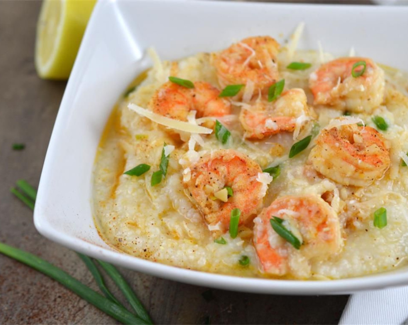 step 7 To serve place grits in individual bowls and top with shrimp mixture. You can always serve family style too in a large platter. Drizzle each bowl/or platter with the extra sauce. Garnish with Fresh Chives (1 Tbsp).