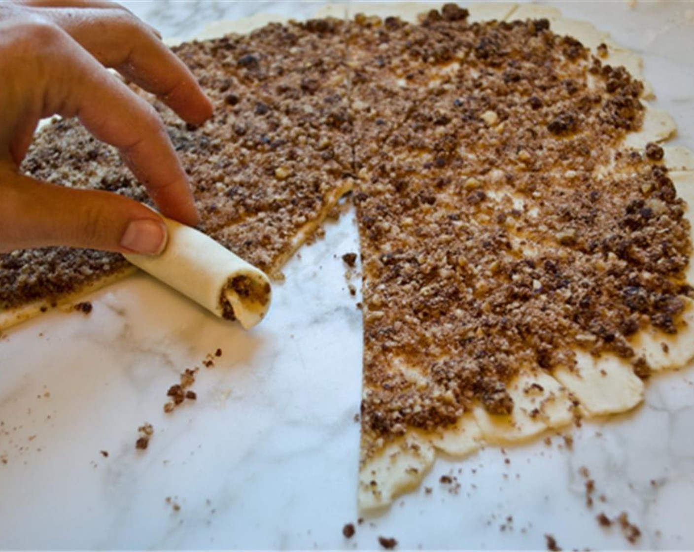 step 9 Using a pizza cutter or very sharp knife, cut the dough into twelve equal wedges. Roll each wedge up, beginning with the wide end and ending with the point.