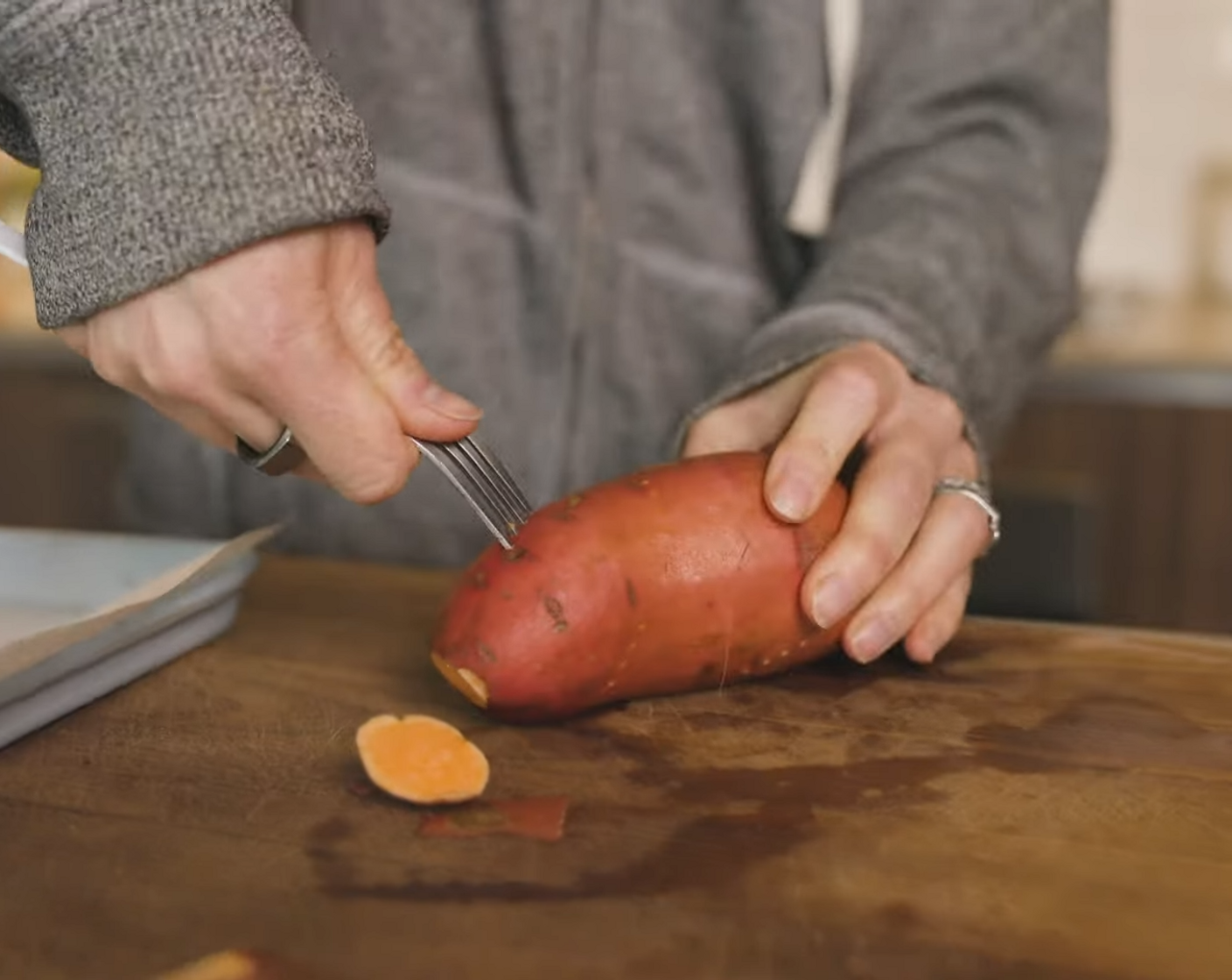 step 2 Using a fork, poke multiple holes into each Sweet Potatoes (2).