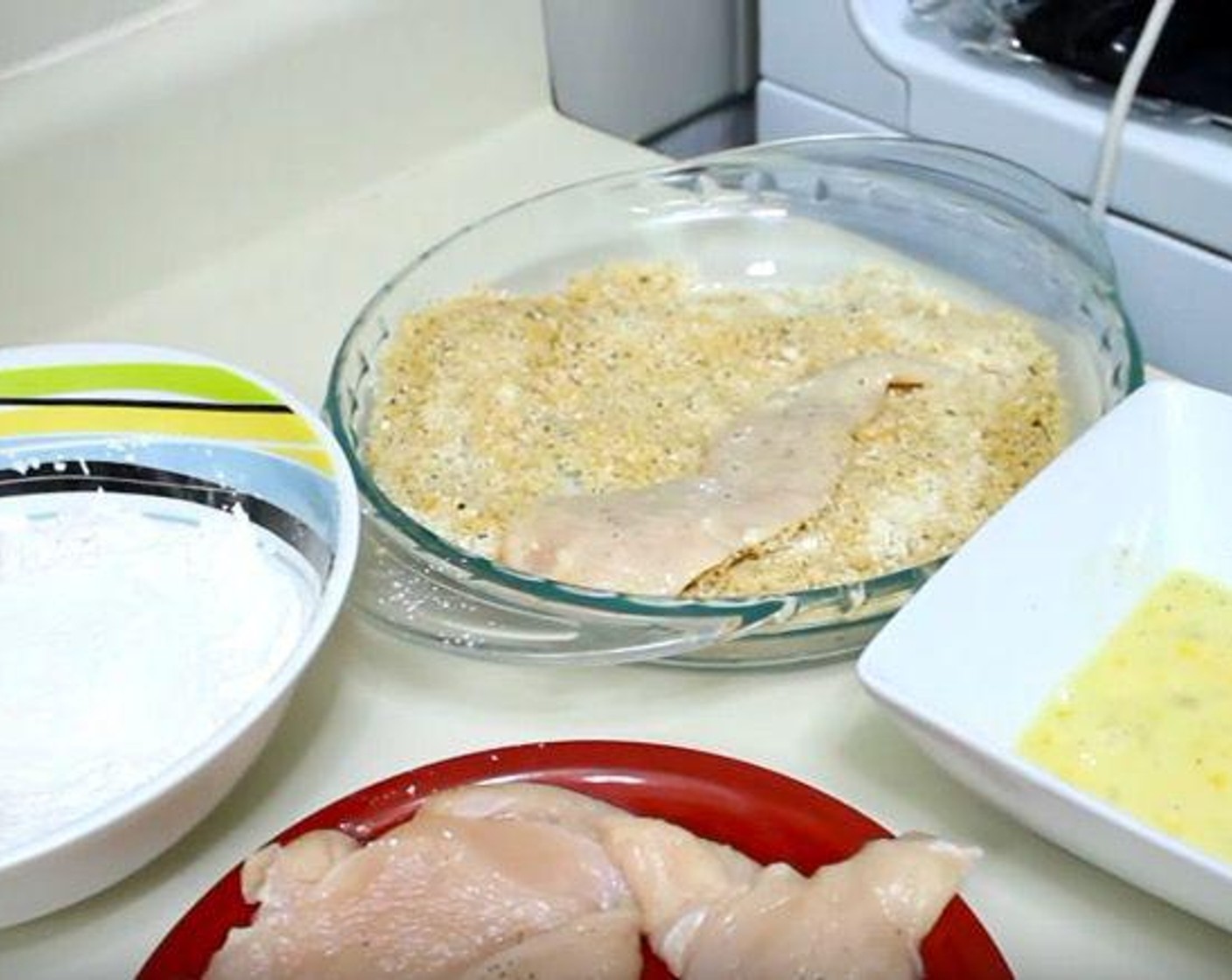 step 2 Dredge the Chicken Breasts (4) in the flour mixture. Then, dip them in the egg mixture. Finally, coat them in the breadcrumb mixture.