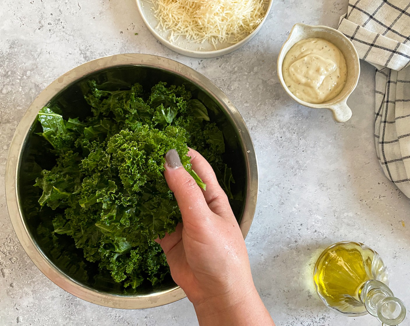 step 8 In a large bowl, massage the remaining olive oil and Lemon (1) into the kale. This is when you can add the Caesar Dressing (1/2 cup), or serve it on the side.