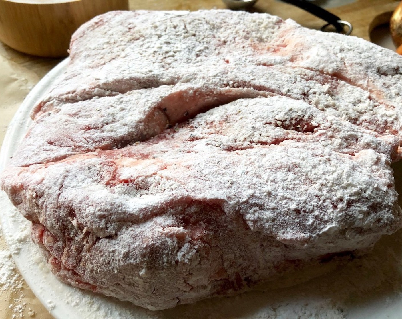 step 2 Pat the Boneless Chuck Roast (1) dry with a paper towel. Season the roast all over with Kosher Salt (1 Tbsp) and Freshly Ground Black Pepper (1/2 Tbsp). Dredge the whole roast in All-Purpose Flour (as needed) including the ends.