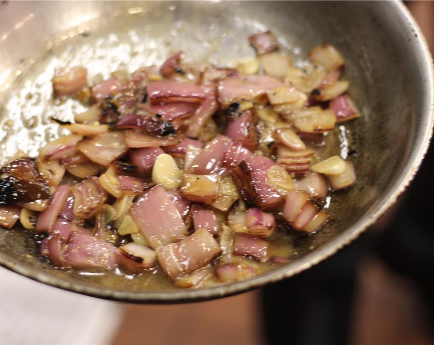 step 4 Heat half of the Olive Oil (1/2 tsp) and half of the Canola Oil (2 tsp) over medium-high heat. Toss in the onions and garlic and cook for a few minutes. Deglaze with Chicken Stock (12 fl oz) and then reduce by 3/4.