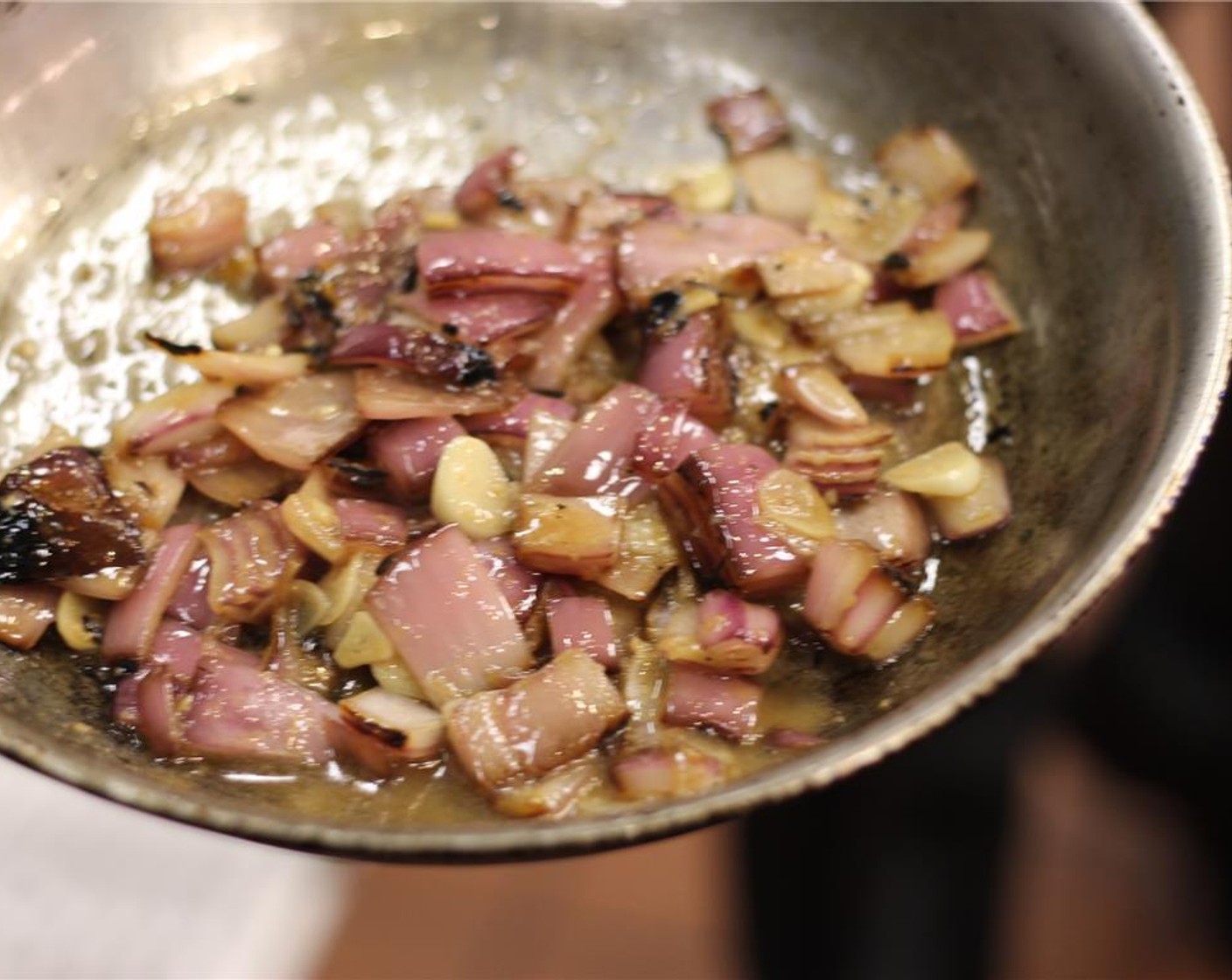 step 4 Heat half of the Olive Oil (3/4 tsp) and half of the Canola Oil (1/2 Tbsp) over medium-high heat. Toss in the onions and garlic and cook for a few minutes. Deglaze with Chicken Stock (12 fl oz) and then reduce by 3/4.