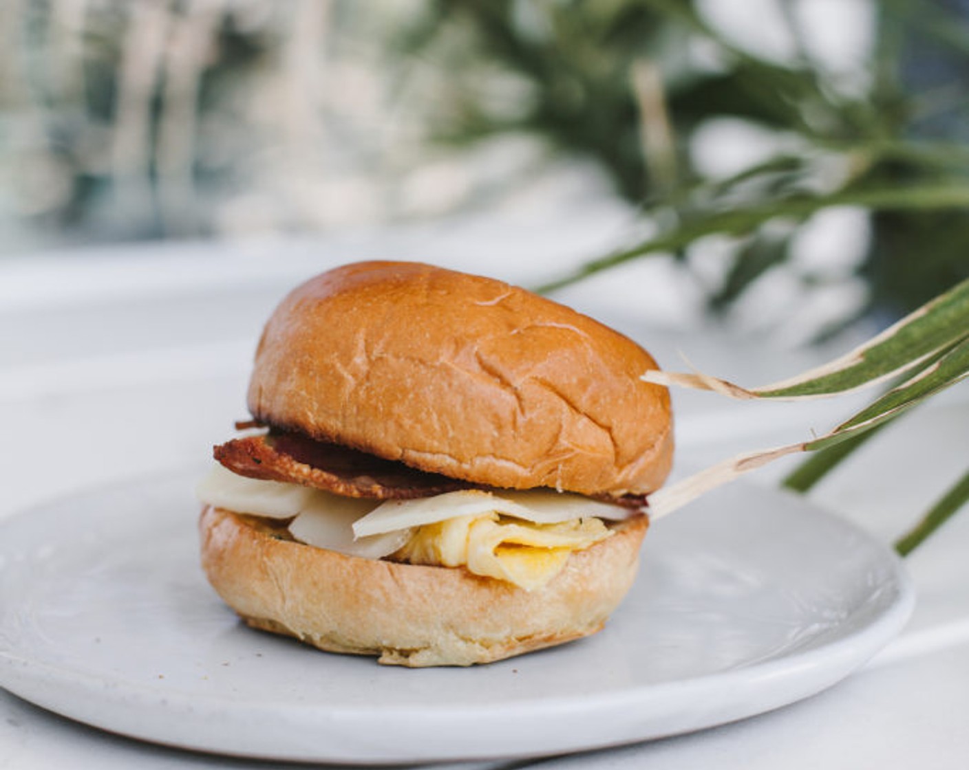 step 4 Slather your brioche bun with the rosemary maple butter, then top with Sharp White Cheddar Cheese (to taste), egg, and bacon.