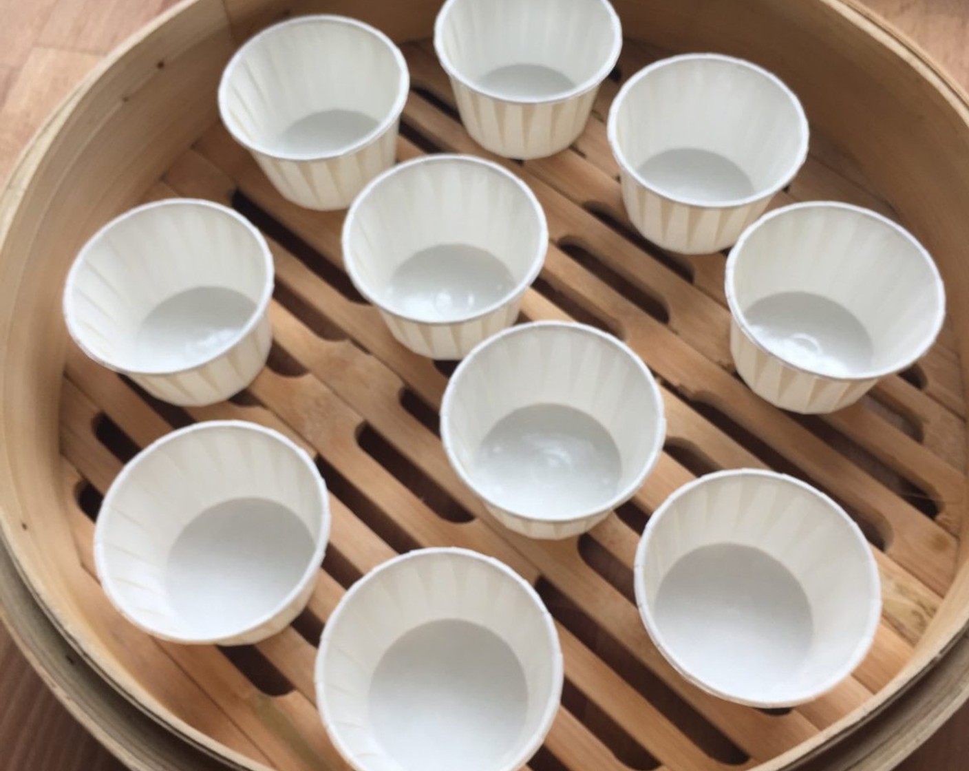 step 12 First, arrange paper cups in bamboo steamer.