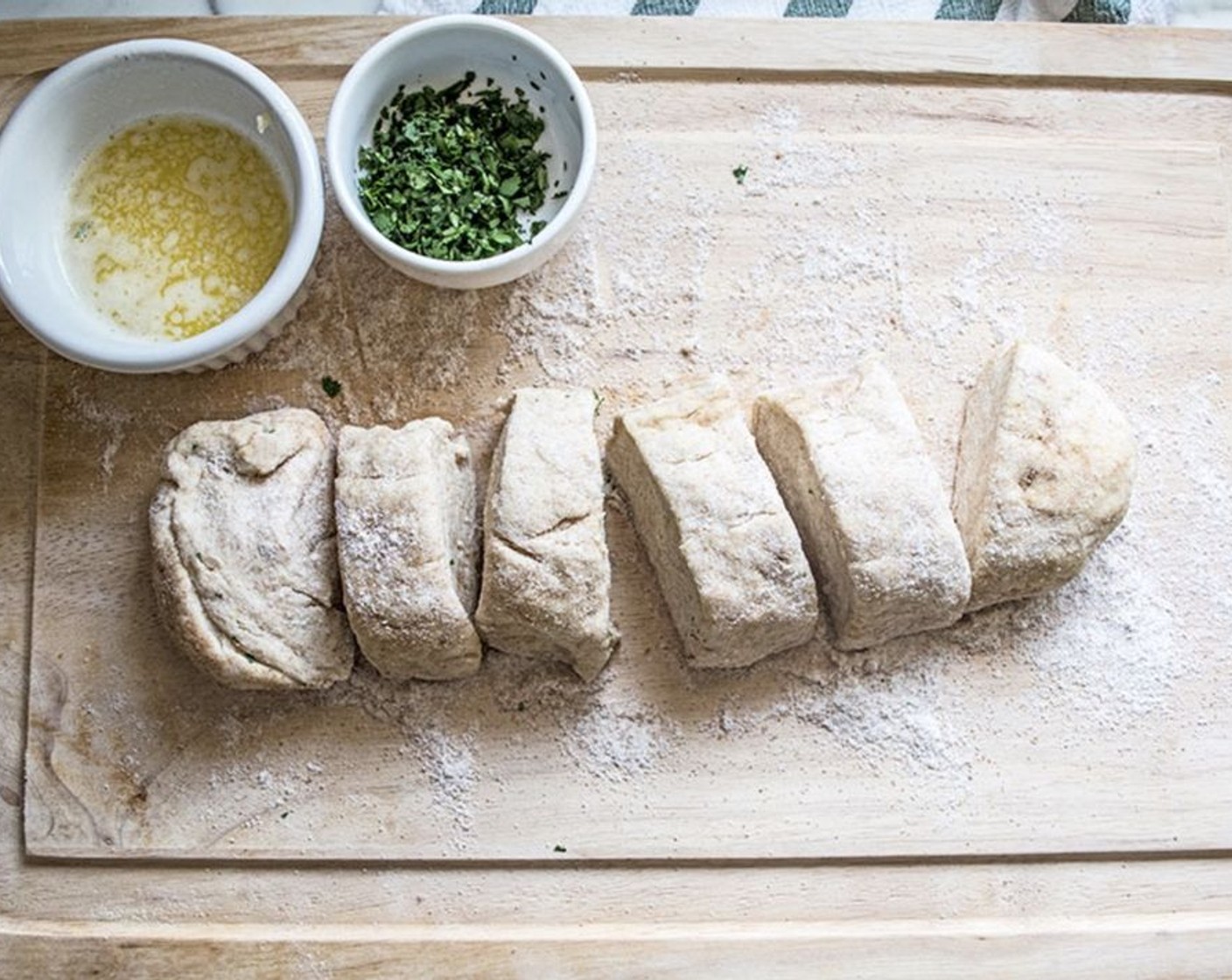 step 6 After the dough has rested for 30 minutes, transfer to a flour-covered breadboard and divide the dough into 6 equal parts.