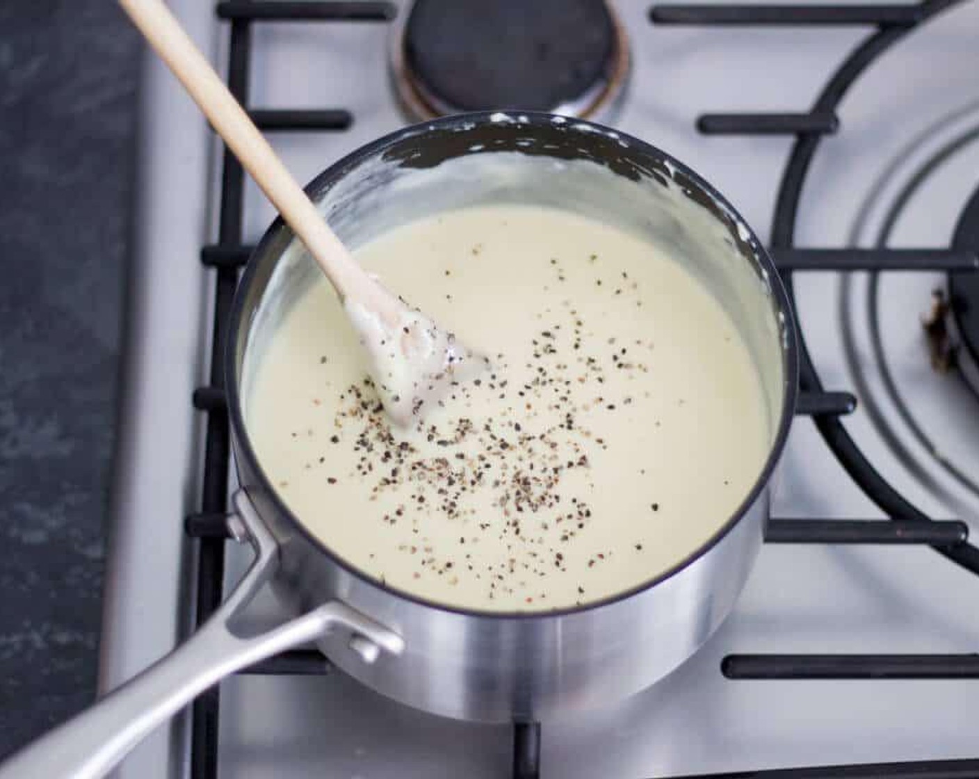 step 7 Now your sauce is ready, let’s add some flavor. Dump in the Honey Mustard (1 Tbsp), Mature Cheddar Cheese (1 1/2 cups), Simply Organic® Garlic Powder (1 tsp) and Simply Organic® Onion Powder (1 tsp) then give it a really good mix. Have a little taste and season well with Salt (to taste) and Simply Organic® Black Pepper (to taste) to your liking.