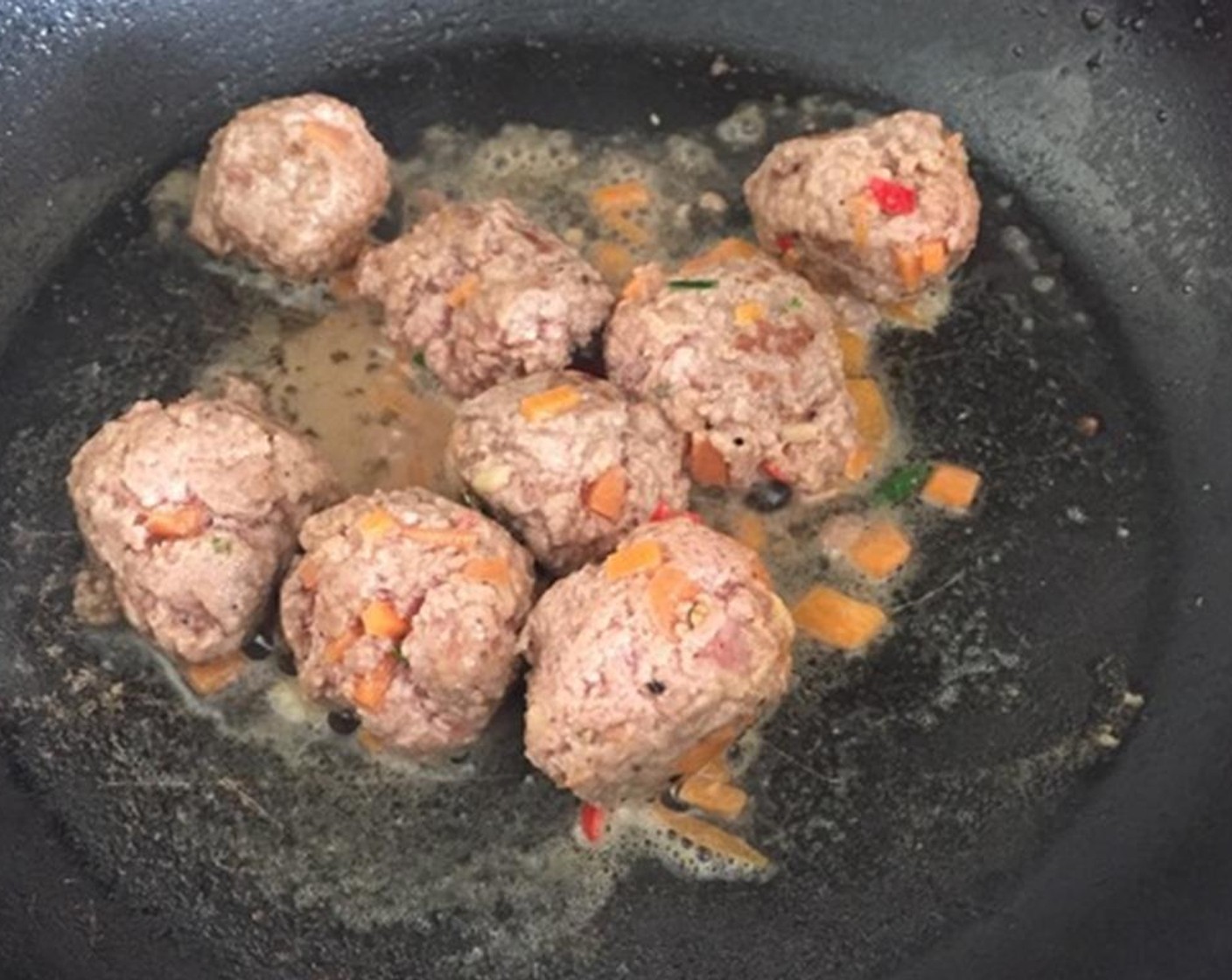 step 2 Put a frying pan over a heat and add Cooking Oil (1 Tbsp) and put the meatballs in. Keep turning until they're browned all over. It takes a few minutes.