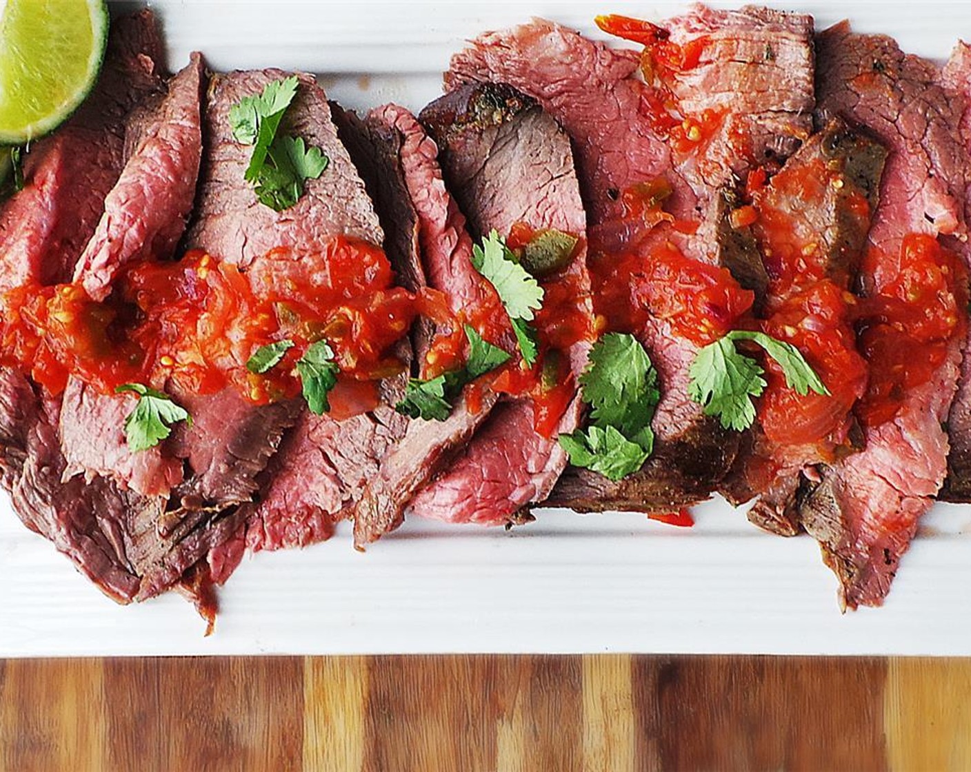 step 9 After the steak has rested, use a carving knife to carve against the grain at an angle. Serve the salsa over the carved meat and a side of grilled Tortillas (to taste).