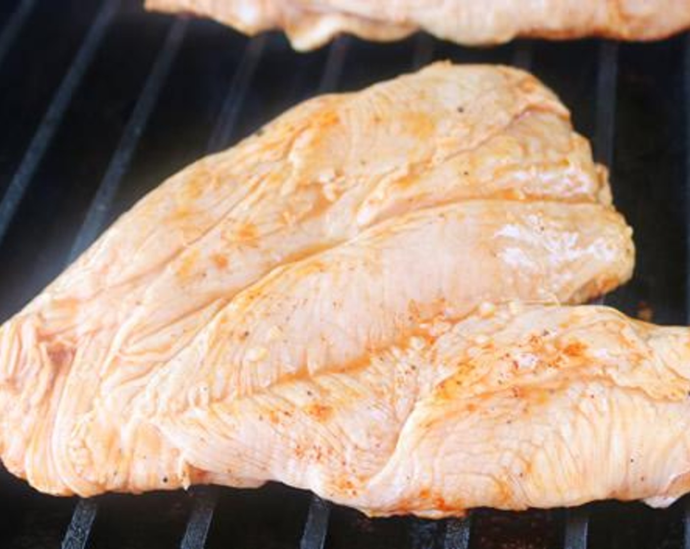 step 5 Remove chicken breasts from marinade and season with BBQ rub. Place directly on grill grates and cook for 8 minutes.
