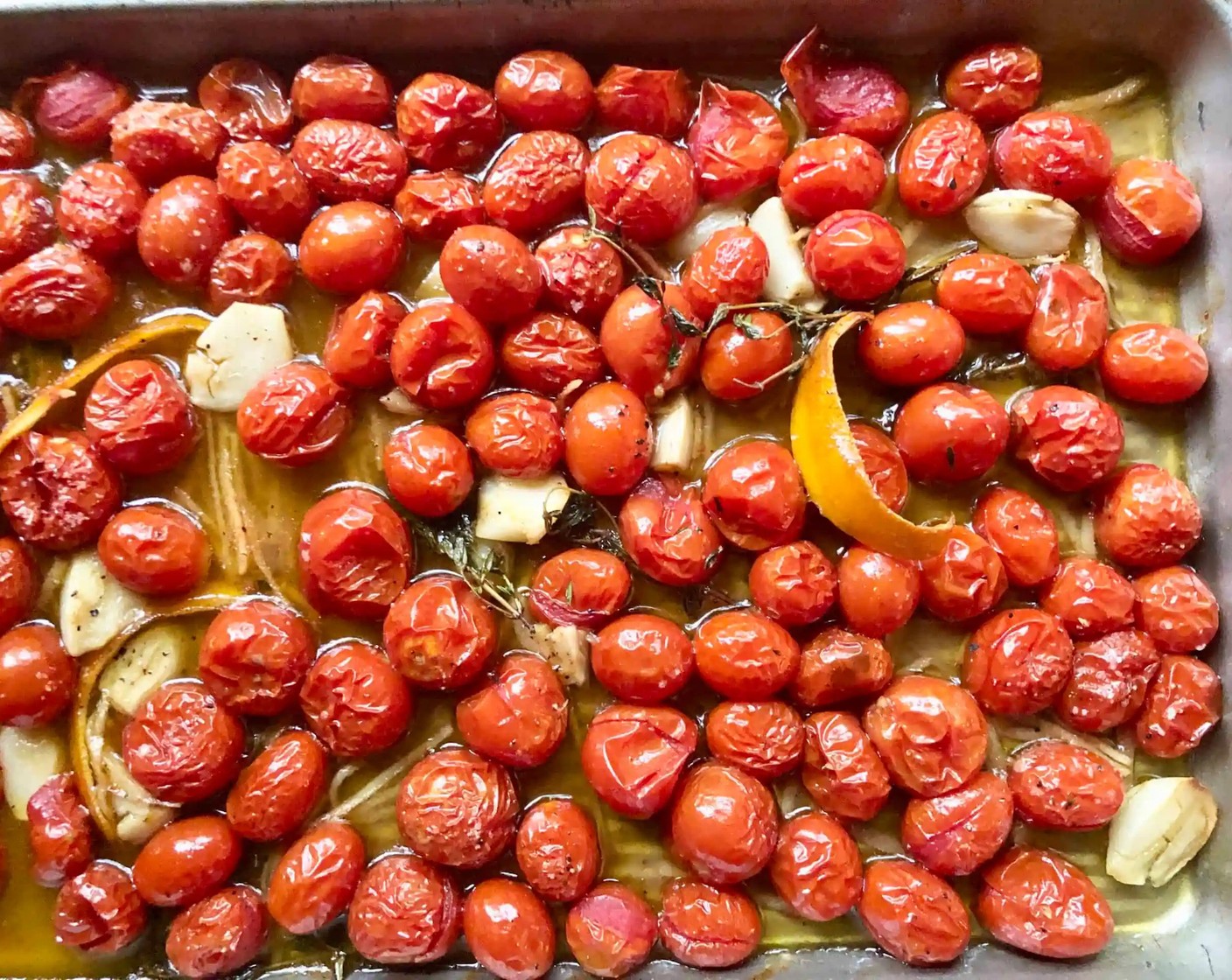 step 6 Roast, gently tossing mixture every 20 minutes, until tomatoes are tender and just bursting but still intact, for 50-60 minutes. Pluck out and discard thyme and orange zest. Set tray aside.