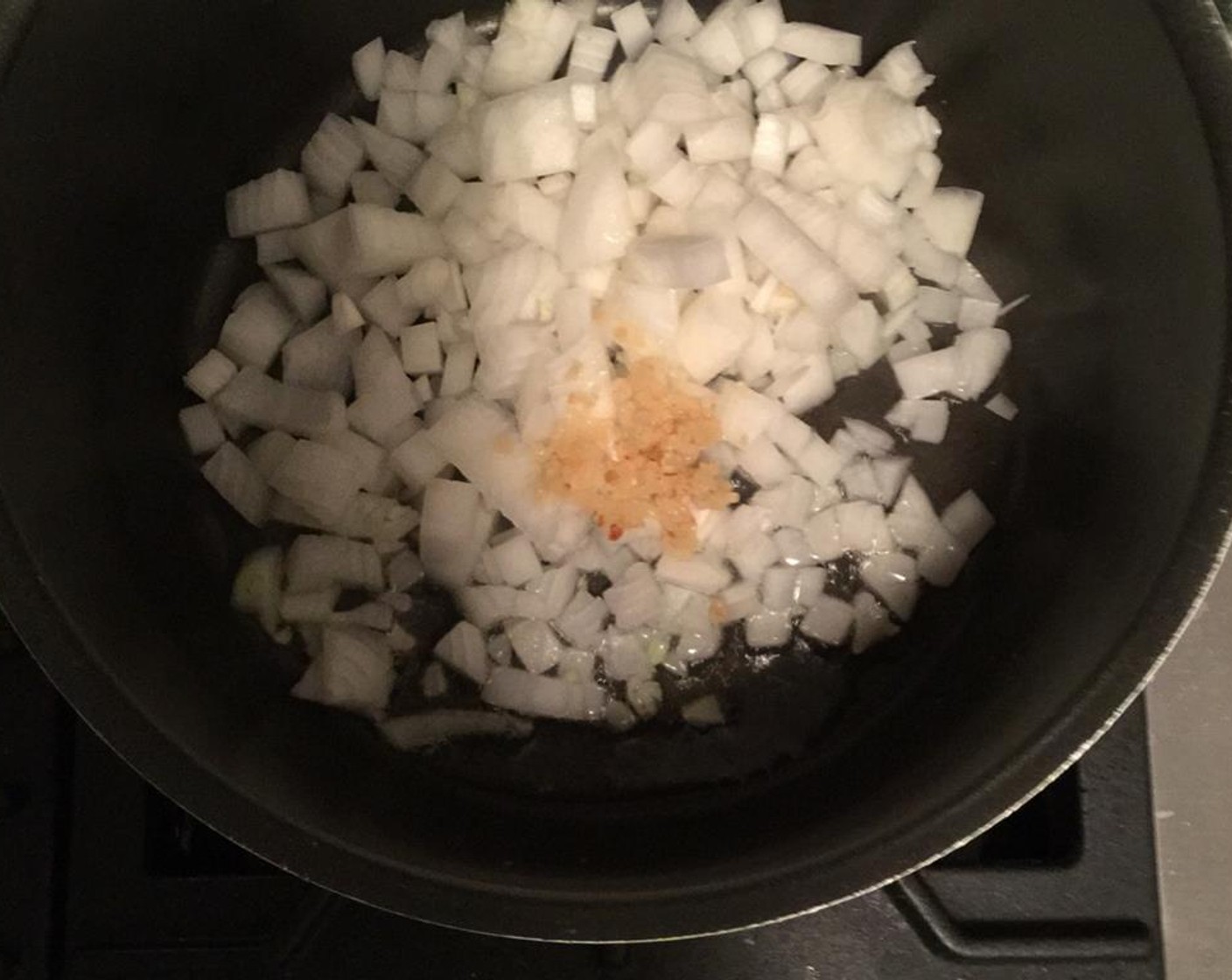 step 3 Heat Vegetable Oil (1 splash) in a pot and fry the onion with garlic until brown.