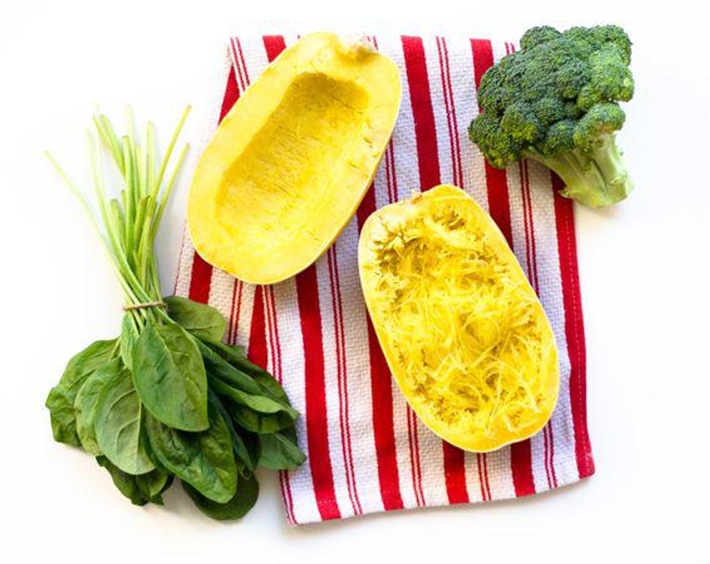 step 1 Cut Spaghetti Squash (1) in half lengthwise and scoop out seeds and gunk around seeds. Brush with Olive Oil (1 Tbsp) and place face down on a baking sheet.