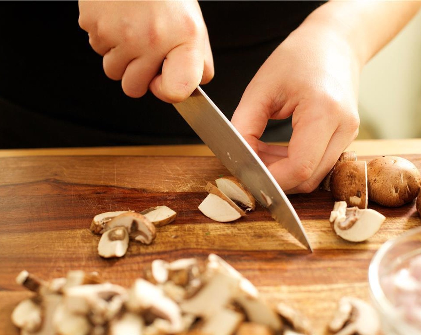 step 5 Slice mushrooms in half, and cut each slice into pieces a quarter inch thick.