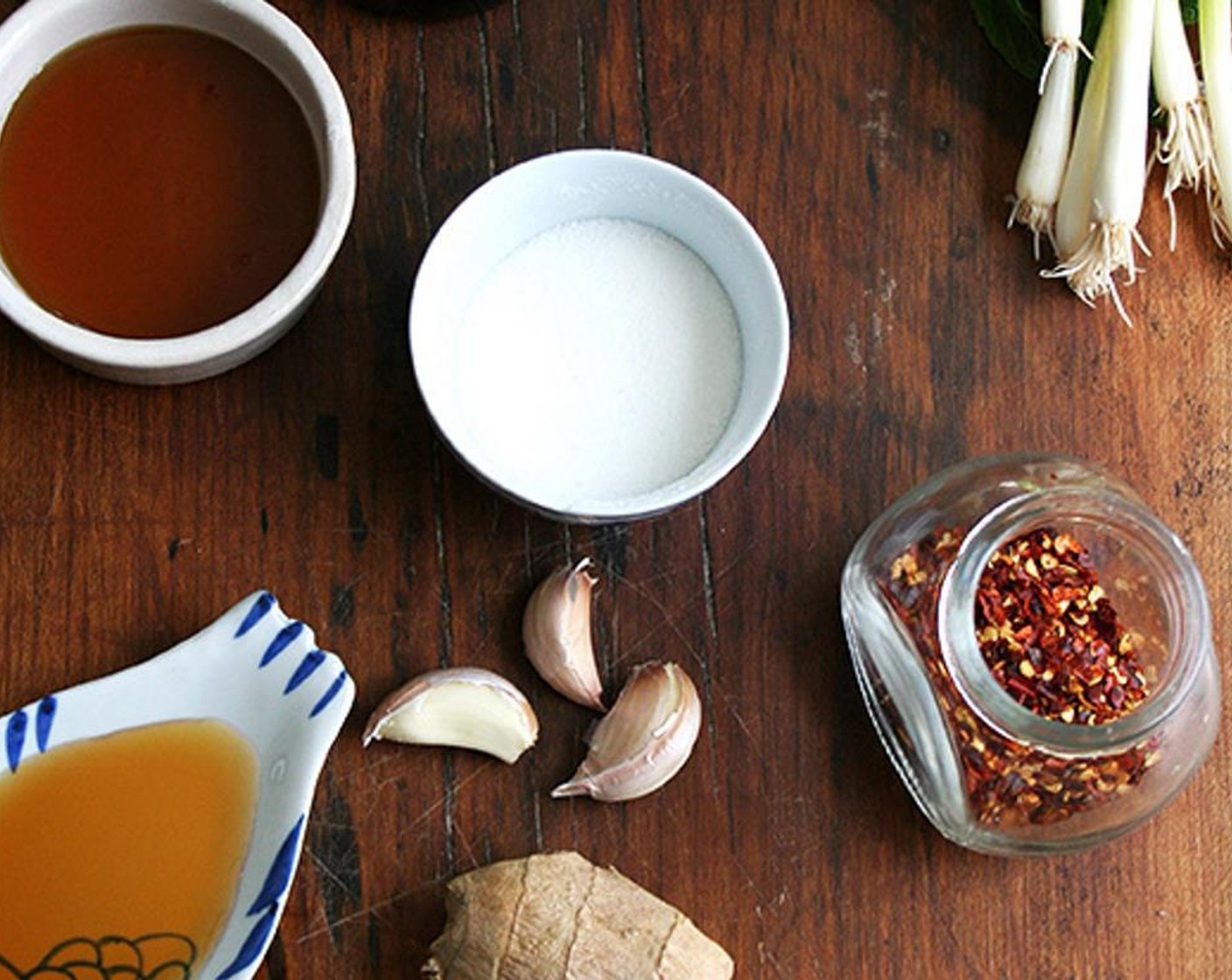 step 1 For the soy dressing, combine Soy Sauce (4 Tbsp), Rice Vinegar (2 Tbsp), Mirin (2 Tbsp), Sesame Oil (1 1/2 Tbsp), Garlic (1 clove), Fresh Ginger (1 in), Sriracha (to taste) in a small bowl.