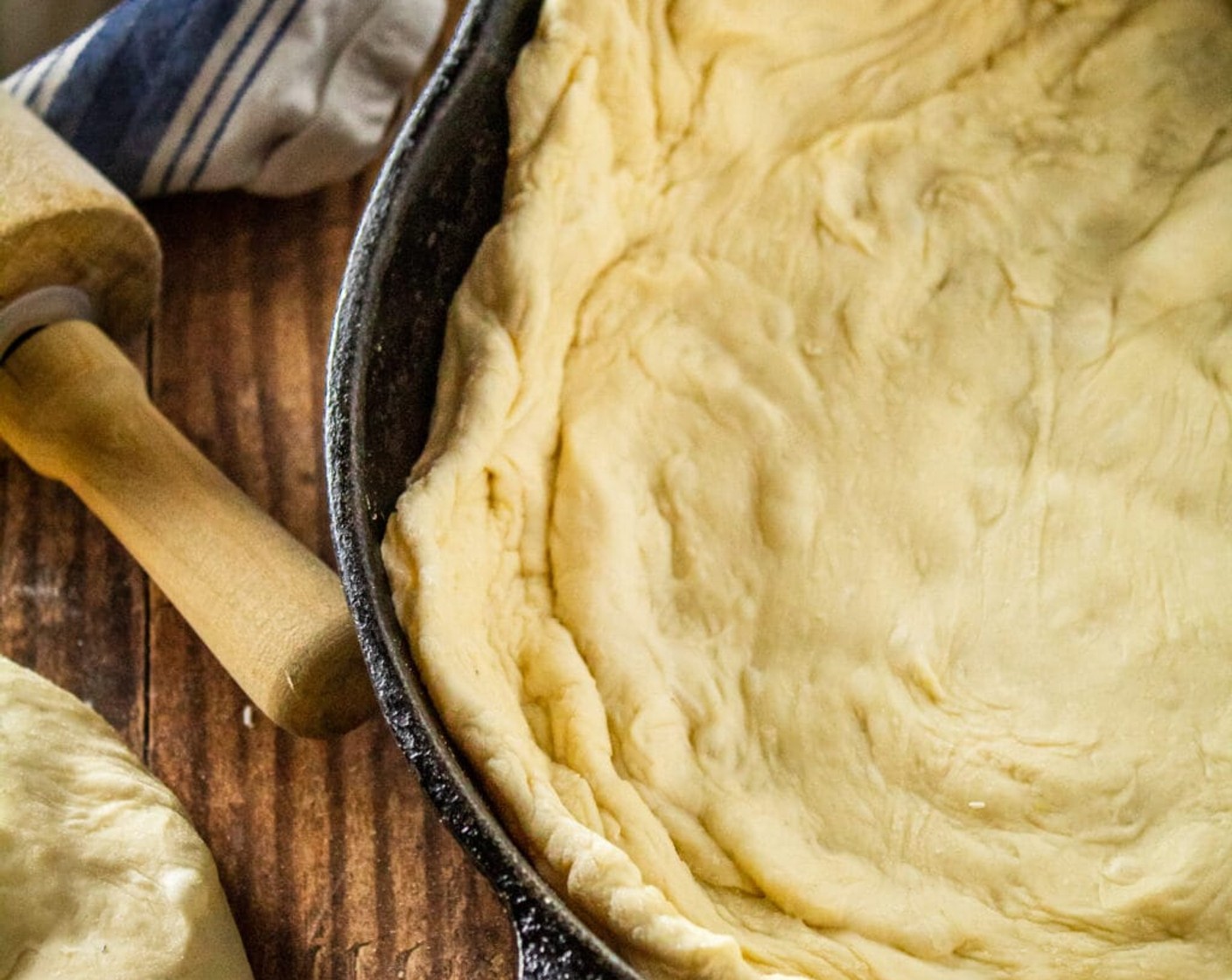 step 8 Let the dough continue to cook for a few more minutes until it starts to puff up and bubble slightly. Using your fingers, create some divets in the dough and then drizzle it with Olive Oil (1/2 cup) and sprinkle with Kosher Salt (1 tsp) and Ground Black Pepper (1/2 tsp).