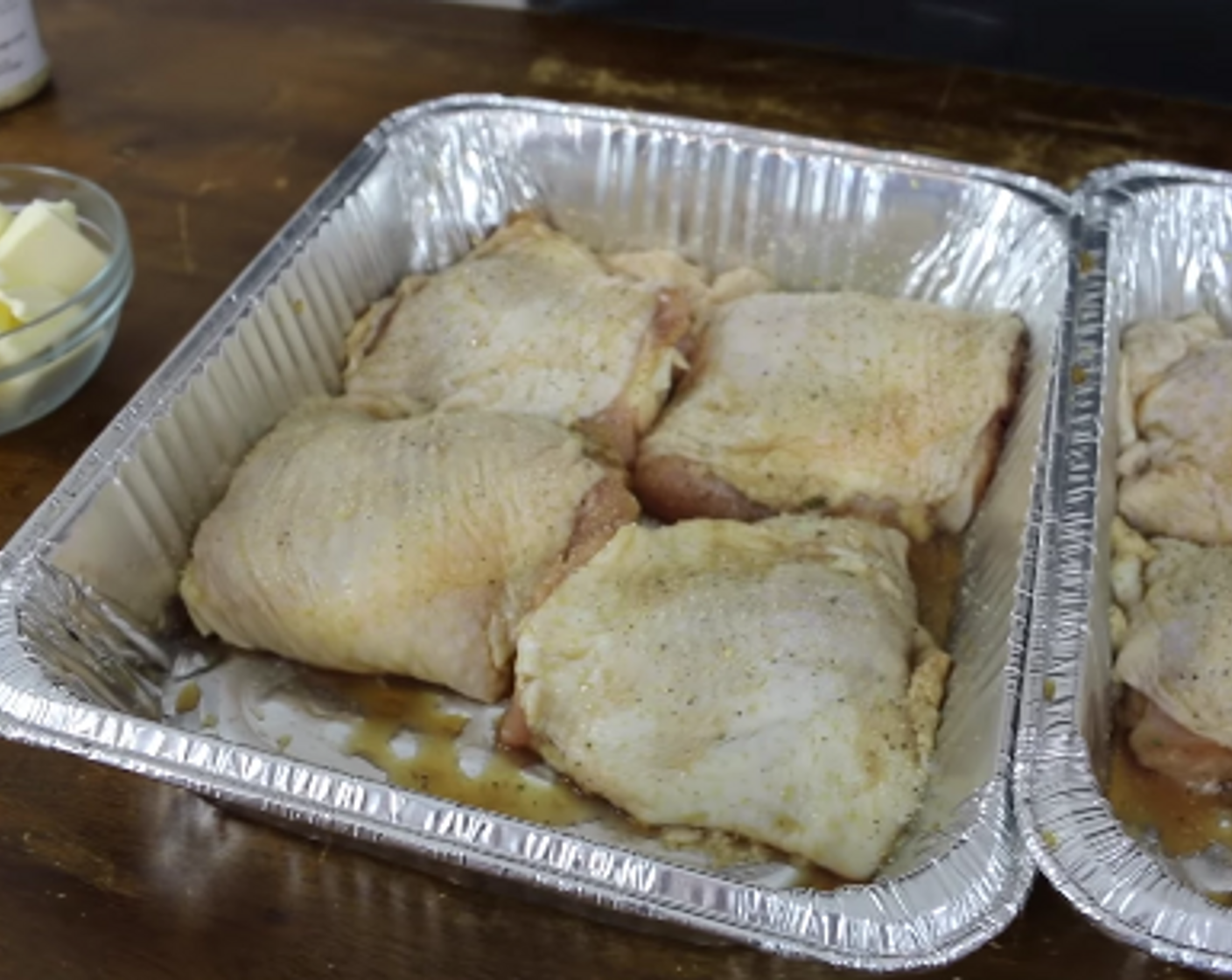 step 3 Remove thighs from bag and shake off any excess brine. Apply light coat of Killer Hog's AP Rub to both sides and place each thigh skin up tightly packed in an aluminum pan.