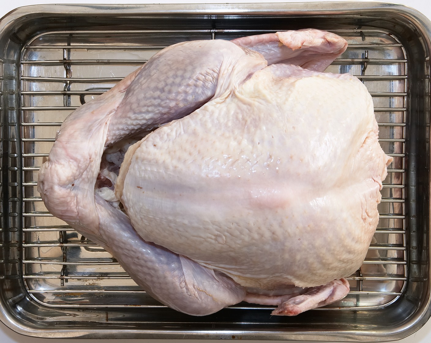 step 2 Place Whole Turkey (1) on roasting pan and pat skin dry.