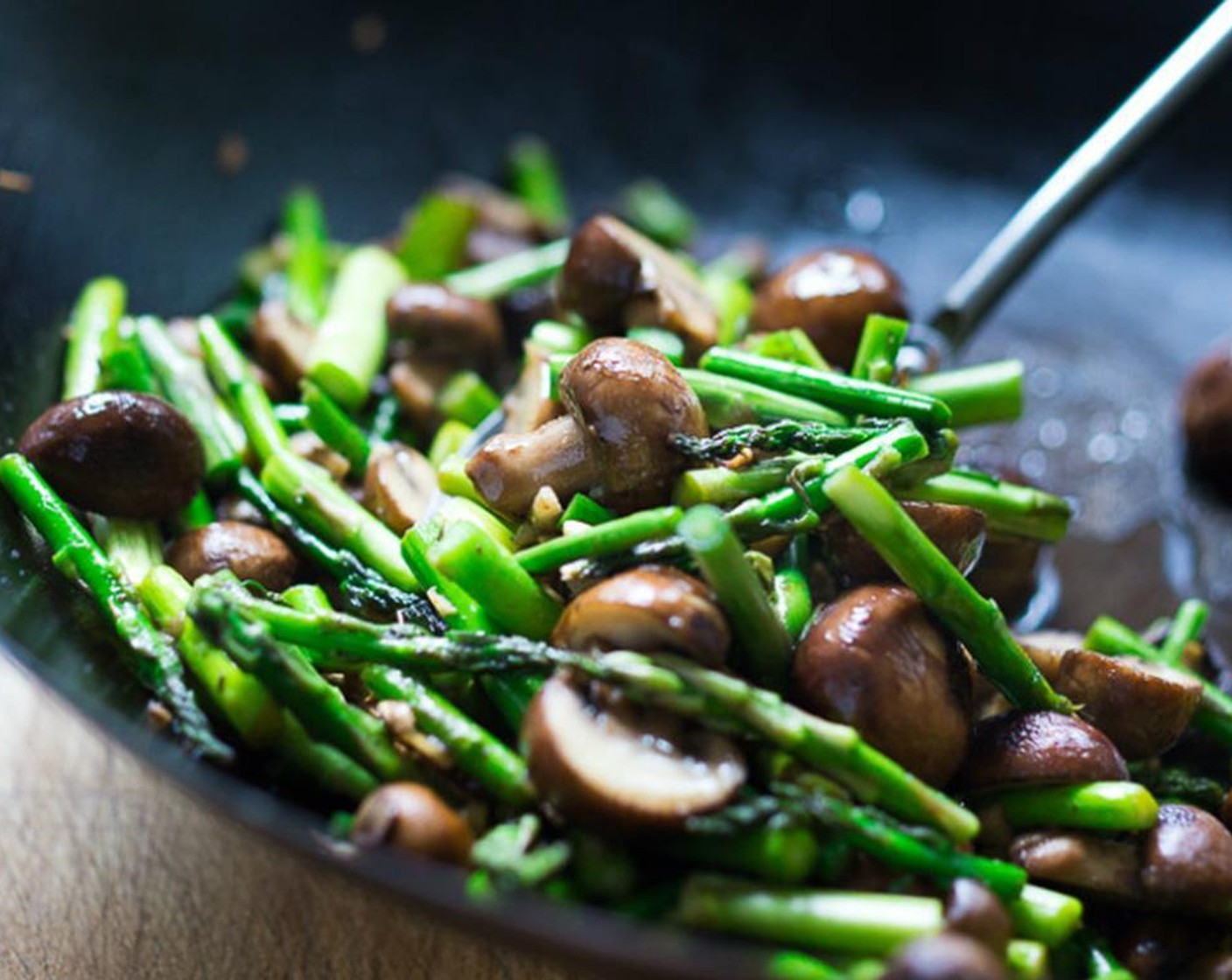 step 9 Add asparagus and garlic, stir for 1 ½ to 2 minutes, until asparagus is just tender, but still crisp and vivid green.