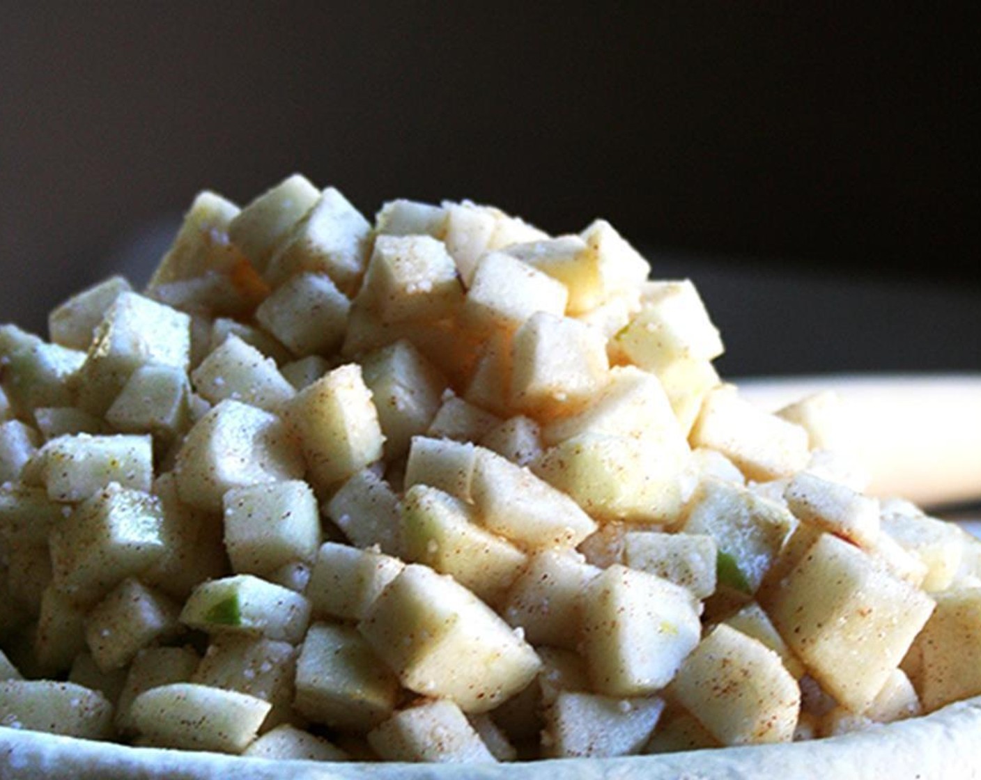 step 9 Taste the apples and adjust the level of sweetness. Dump the apples into the center of your pie plate, using your hands to keep as many apples from tumbling out as possible. Cut the Butter (2 Tbsp) into small cubes and scatter them over the apples.