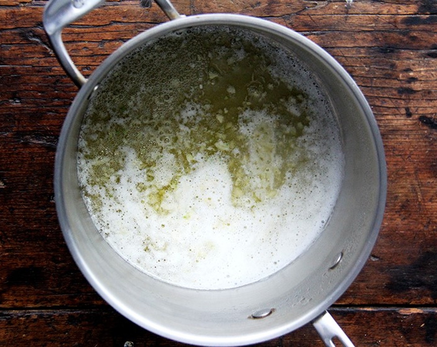 step 5 In a large heavy saucepan, cook Garlic (1 clove) in Unsalted Butter (1/4 cup) over moderately low heat, stirring, until softened.