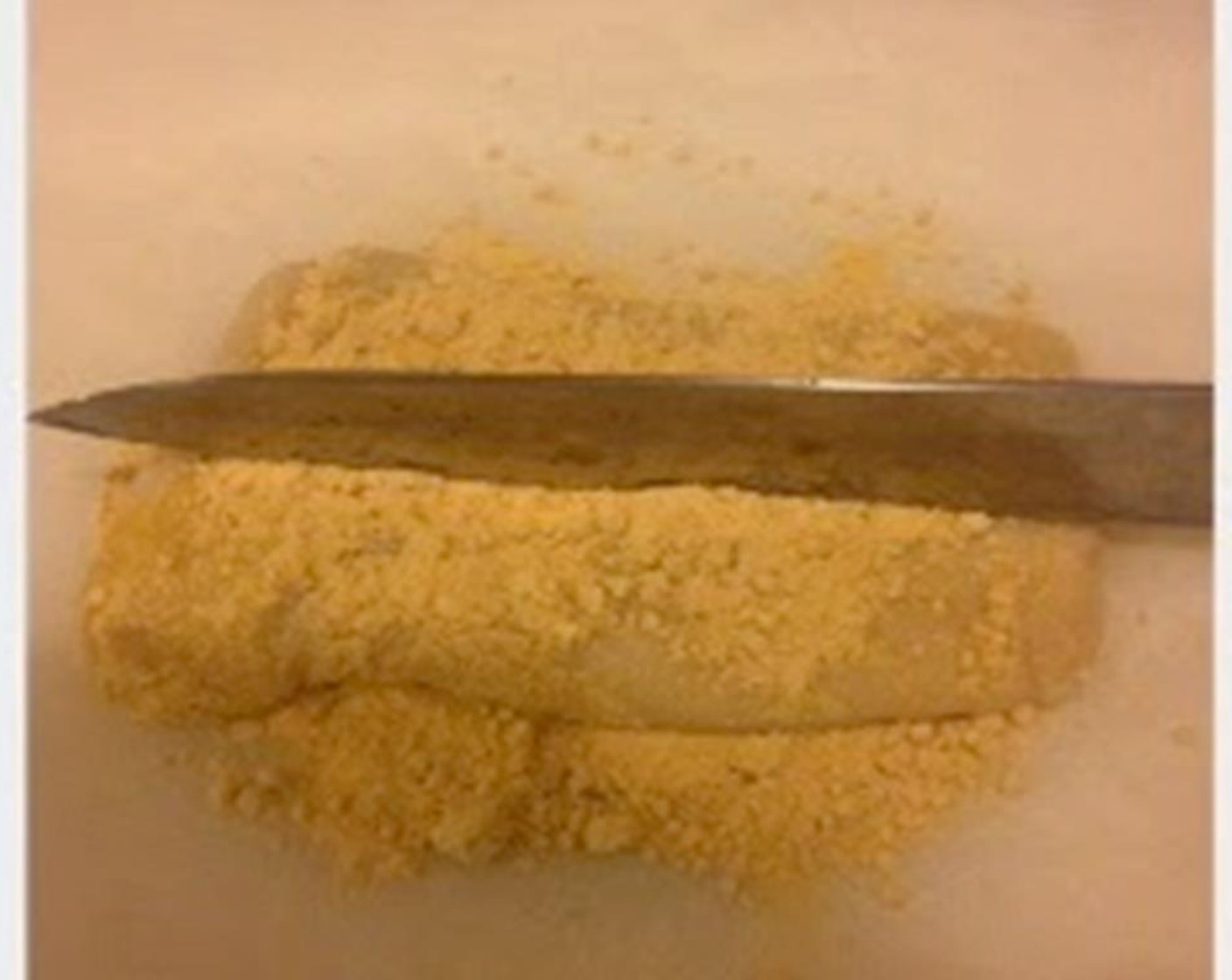 step 4 Put half of the Soy Flour (1 cup) on parchment paper. Take the cooled-down mochi out and coat it with soybean powder. Use a knife to cut mochi into cubes and put more soybean powder on. Coat evenly.