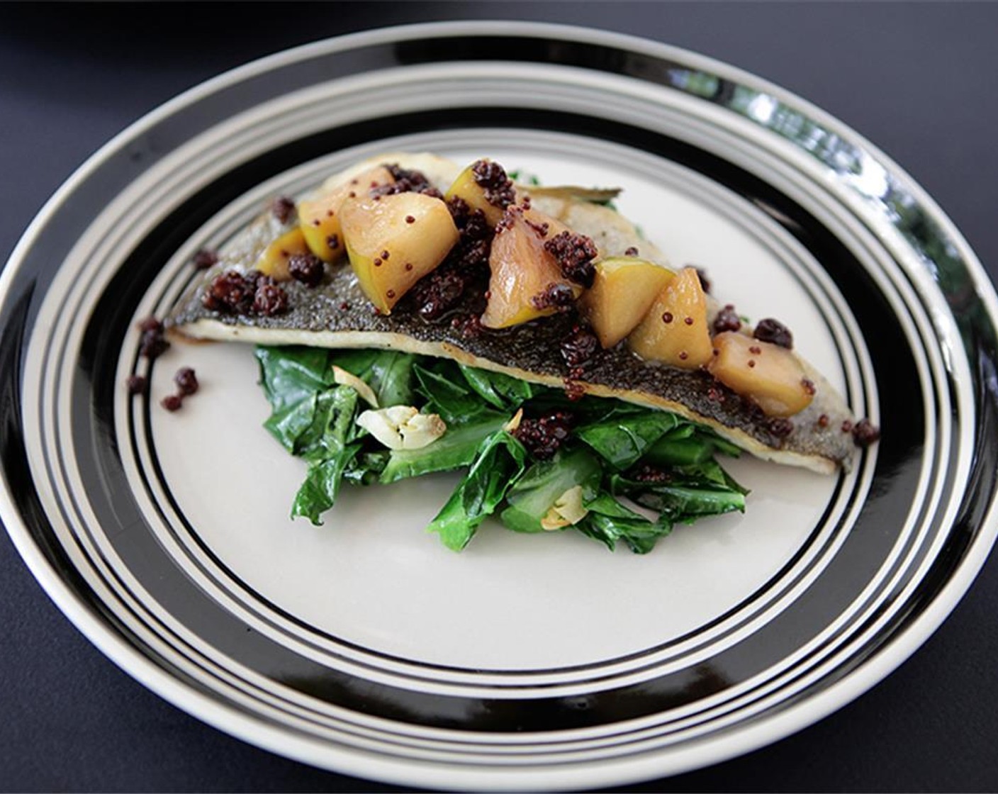 step 9 Place a mound of greens in the center of your plate, and top with trout fillet, skin-side up. Spoon mostardo over the trout.