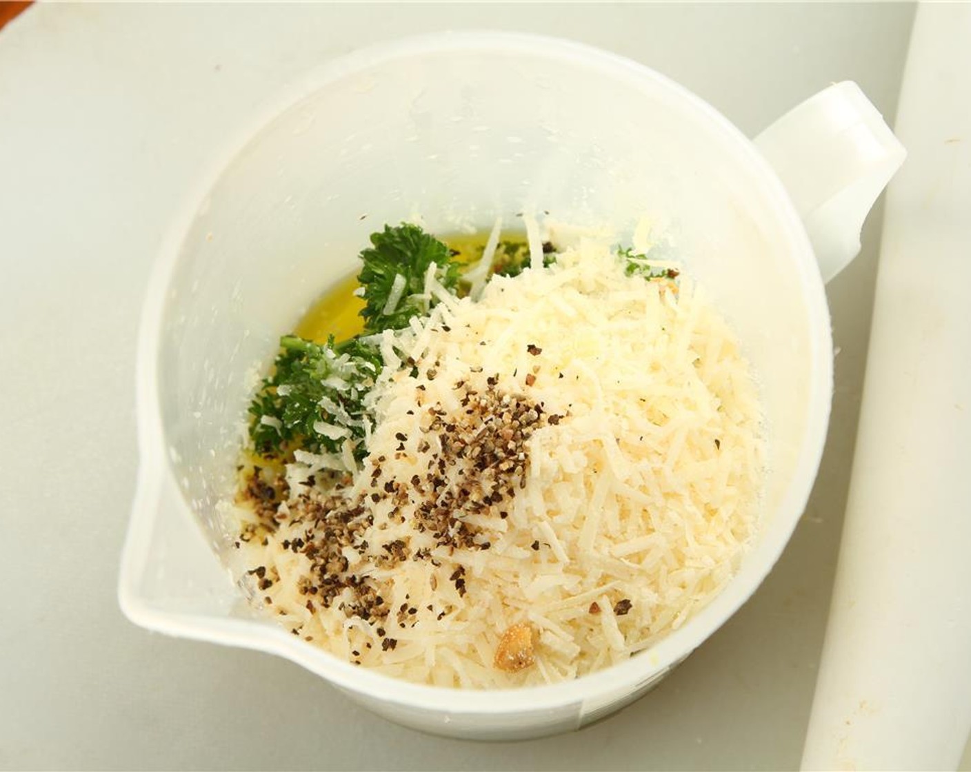 step 5 Add the Garlic (1 clove), Salt (1 1/3 Tbsp), Fresh Parsley (1/2 cup), Olive Oil (3/4 cup), Parmesan Cheese (1 1/3 cups), Ground Black Pepper (2 tsp), Shallot (1), and Anchovies (3 1/2 Tbsp) to the same jar.