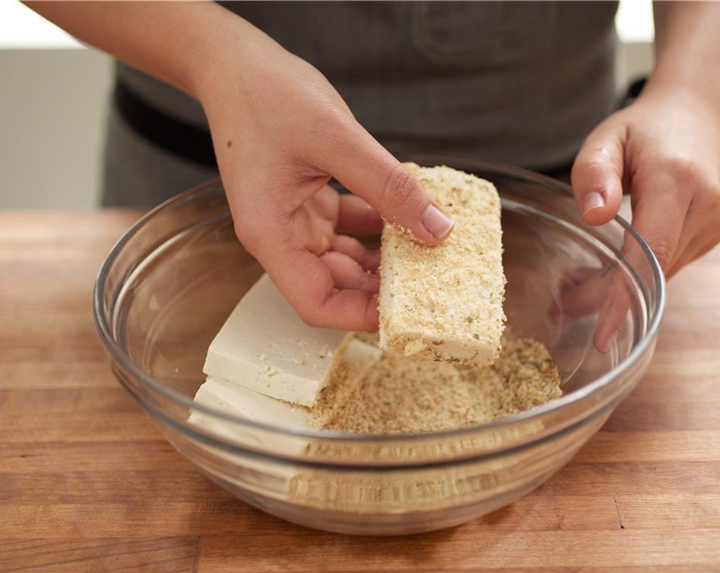 step 5 One at a time, press tofu slices into bread crumb mixture and turn to coat all sides.