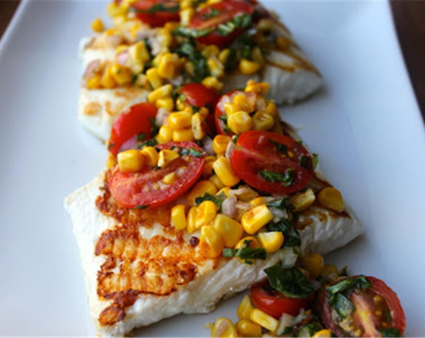 step 10 Serve your grilled halibut topped with cherry tomato and corn salsa.