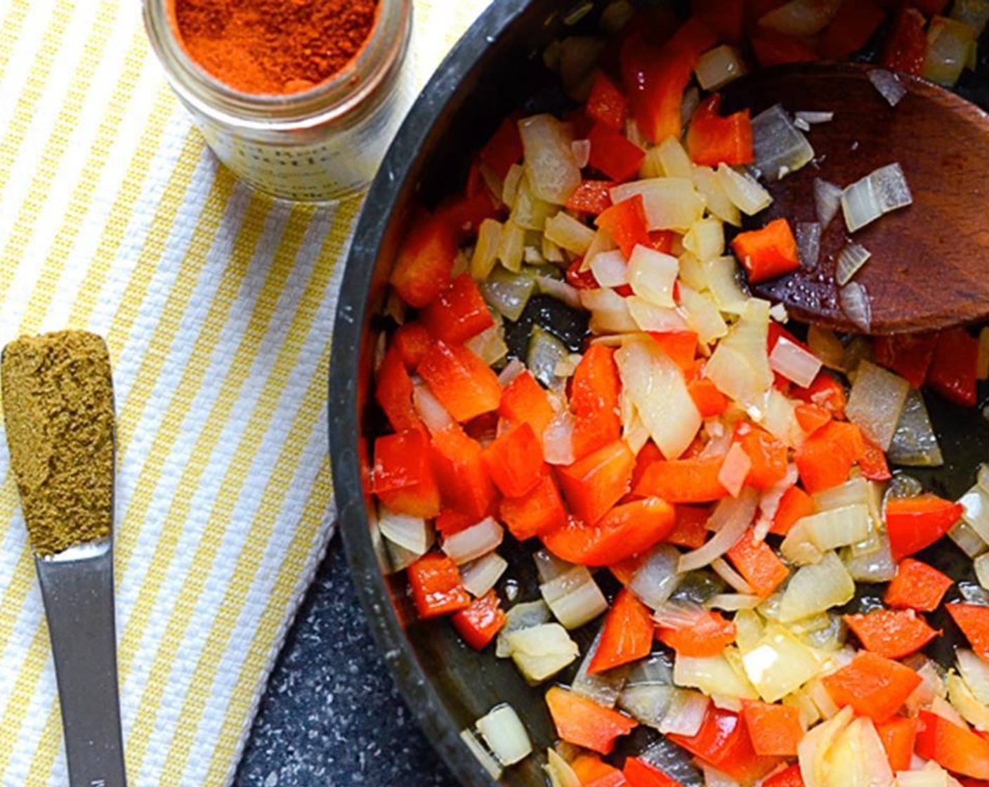 step 2 Heat Olive Oil (1 Tbsp) in a medium saucepan over medium high heat. Add Onion (1), larger chopped bell pepper, and Garlic (2 cloves) and sauté for 2 to 3 minutes until softened and slightly translucent.