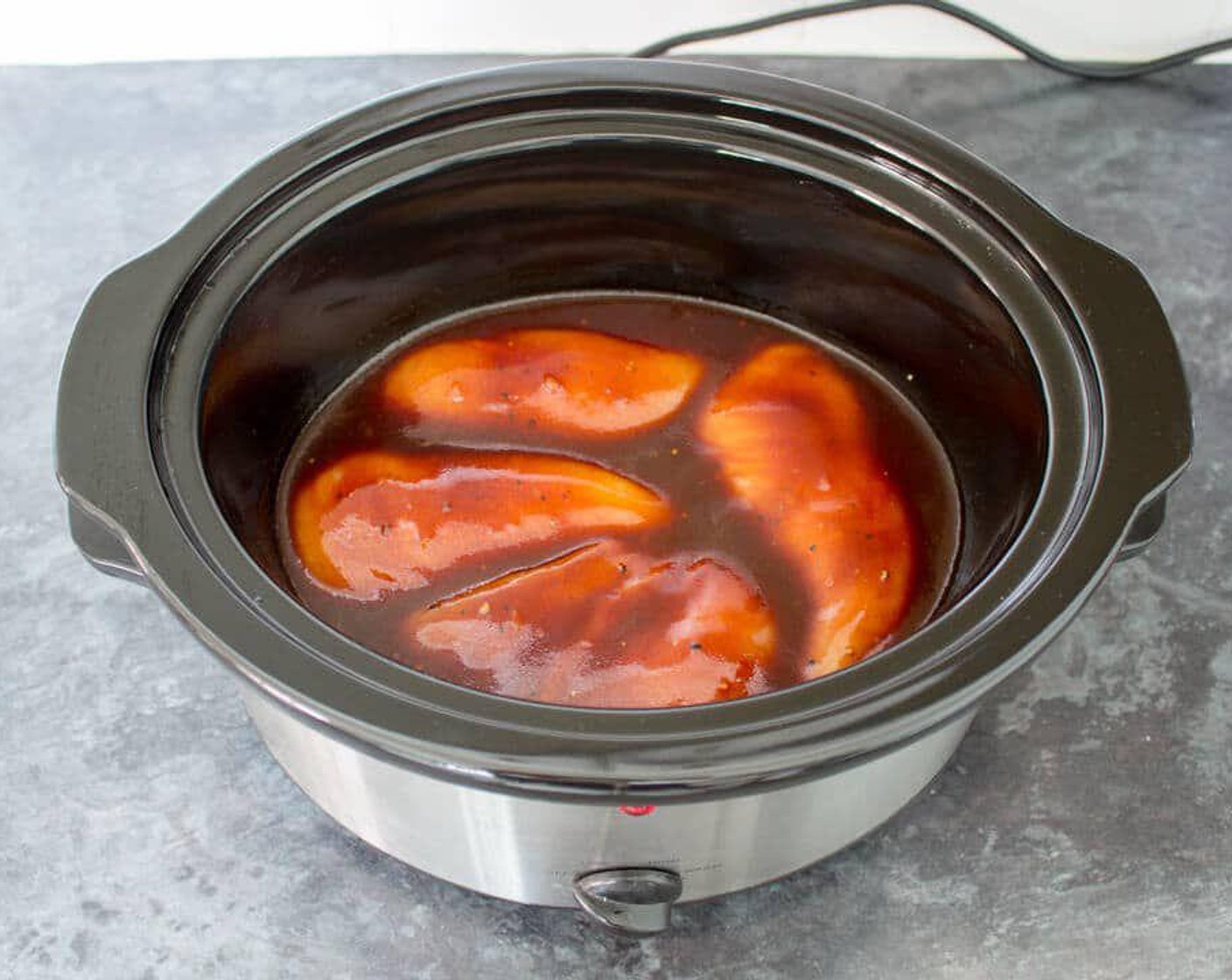 step 3 Pour the sauce into the slow cooker and mix until the chicken is completely covered.