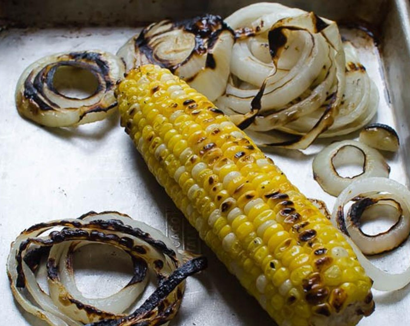 step 2 Place the corn and sliced large sweet onion on the grill and cook, turning every so often to avoid burning until the corn and onions are tender and have taken on a little char. Transfer the vegetables to a sheet pan and set aside.