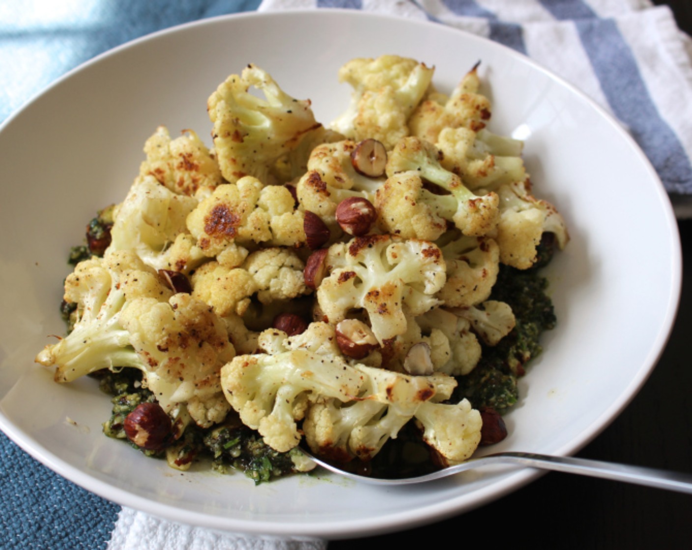 step 7 Spread pesto on a serving platter and spoon the cauliflower on top. Serve hot. Enjoy!