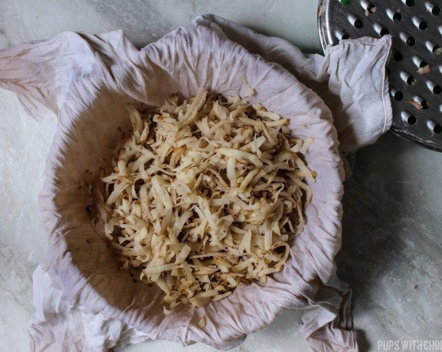 step 4 Place a cloth inside a bowl and add all the shredded potatoes inside the cloth.