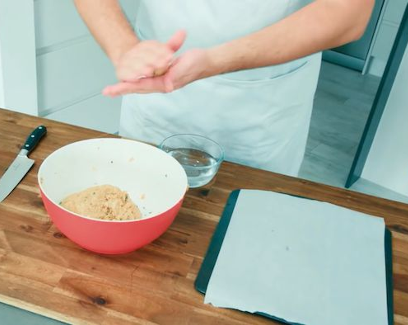 step 13 Now to form the Italian meatballs! Make sure you have cleared the space you are working on and prepare a tray with some baking paper on top. Wash your hands thoroughly, keeping them a little bit wet to make it easier to work the mixture.